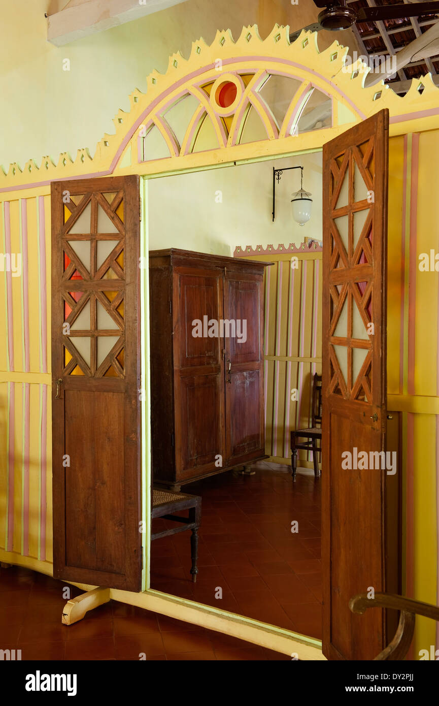Wooden cabinet viewed through doorway of screen partition in Goan house Stock Photo