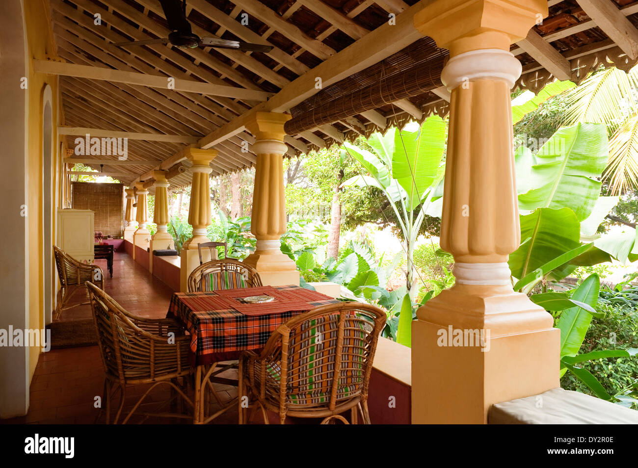 Table and chairs on veranda of Goan home Stock Photo