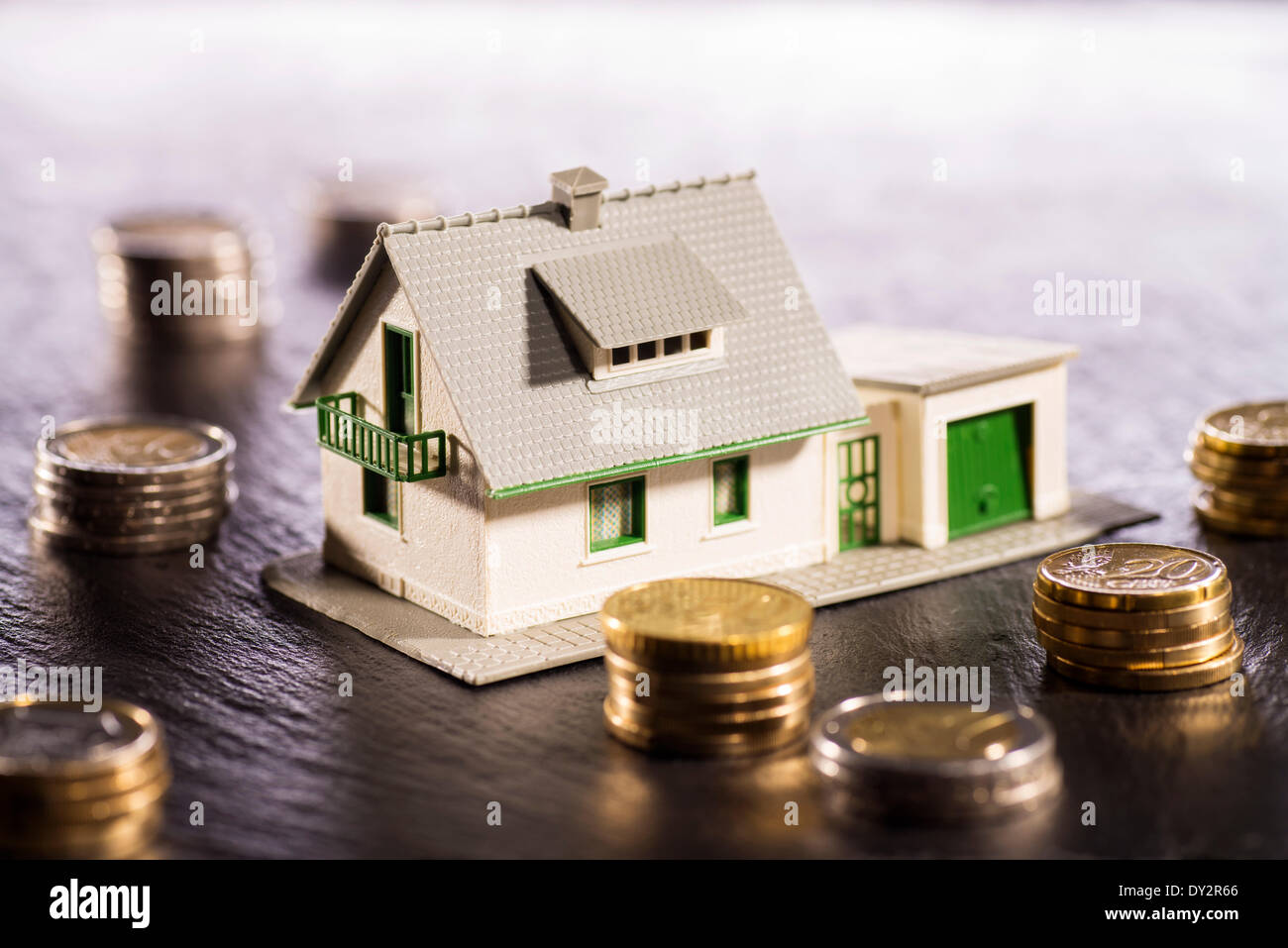 Older house is surrounded by coins. Illustration - March 2014 Stock Photo