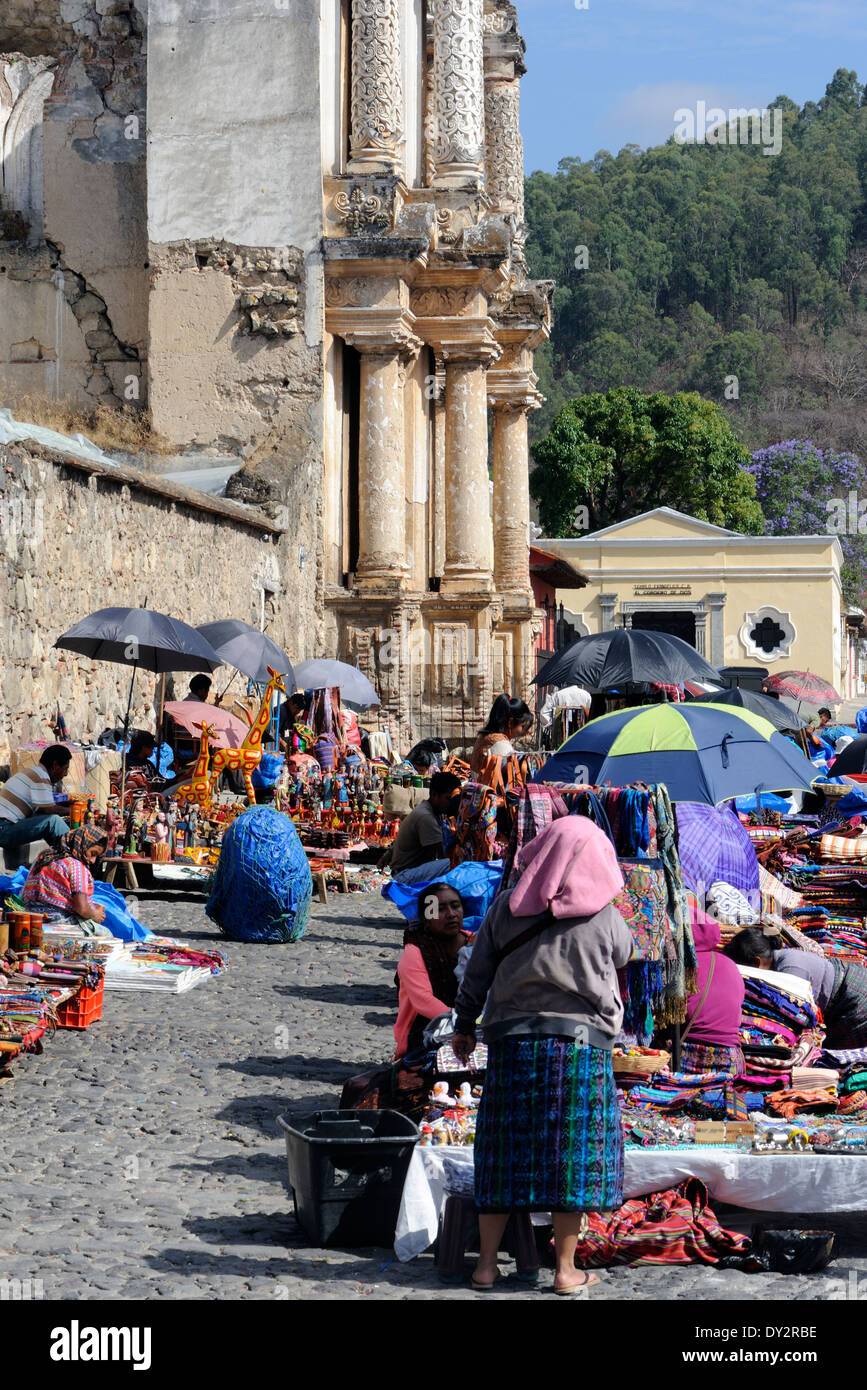 Sellers of crafts including woven goods and, strangely, giraffes.   Antigua Guatemala, Republic of Guatemala. Stock Photo