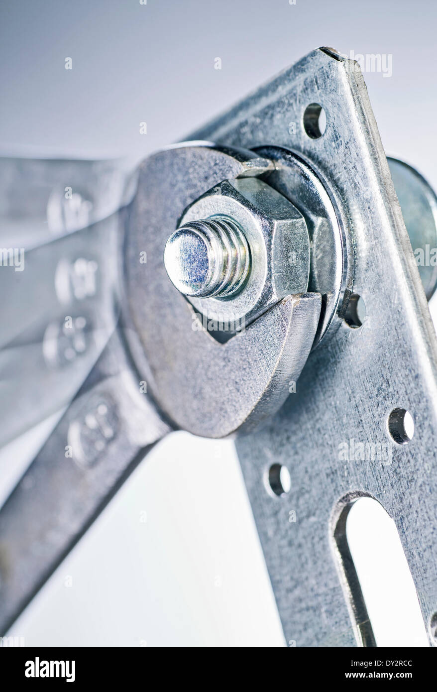 Close up of a wrench tightens a nut. April 2014 Stock Photo