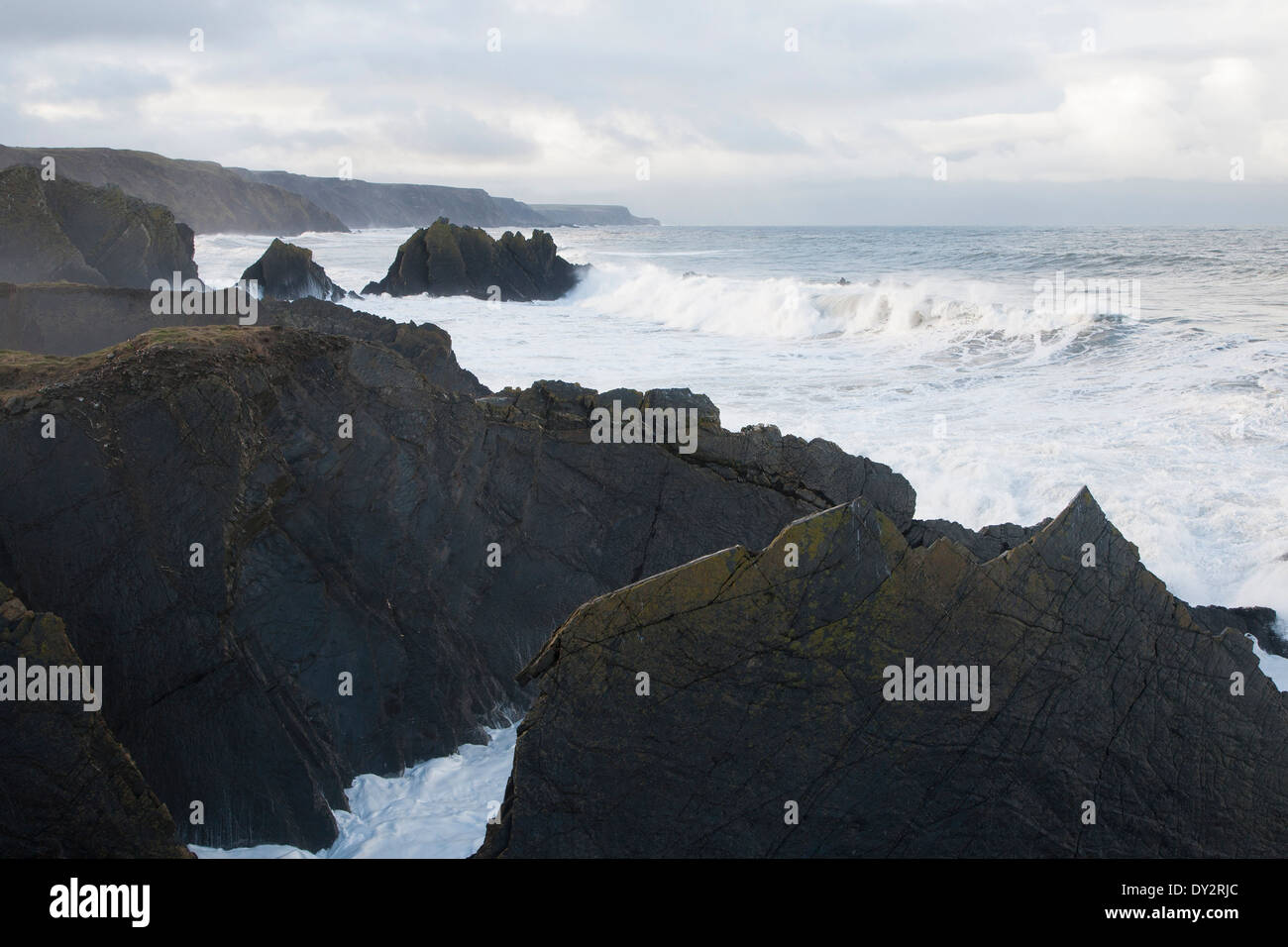 Large Atlantic storm waves crashing onto jagged rocky coast at Hartland Quay, north Devon, England Stock Photo