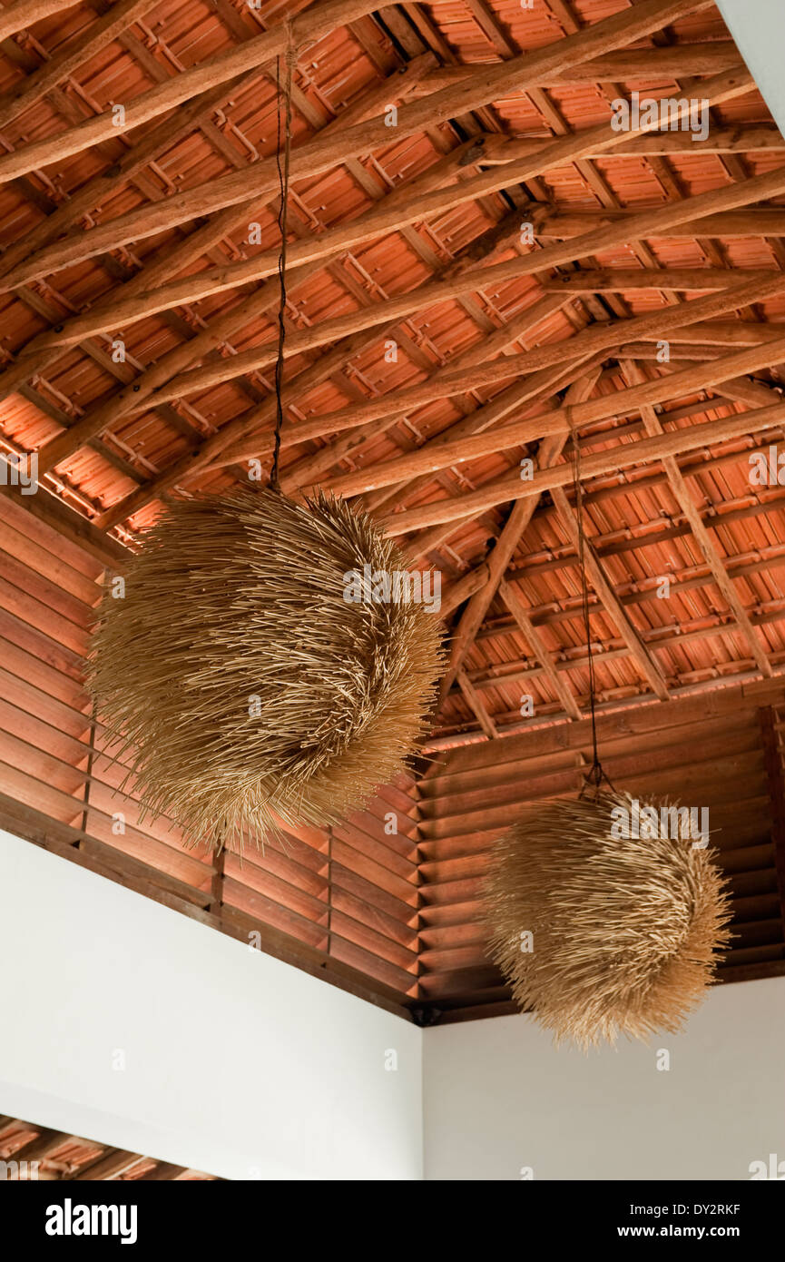 Textured pendant shades hang from beamed ceiling of beach house retreat in the Indian state of Goa Stock Photo