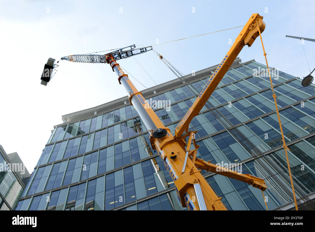 Construction Crane lifting heavy load in city centre Birmingham Uk