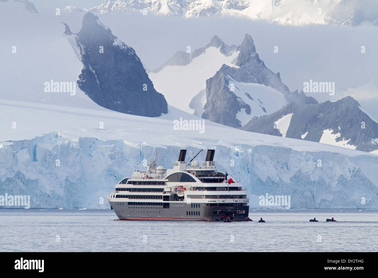 Antarctica cruise ship Antarctica tourism with tourists, L'Austral, and Zodiac among glacier, mountains, mountain, Antarctic Peninsula. Stock Photo