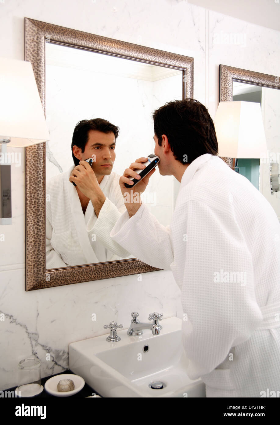 Man shaving in the bathroom mirror Stock Photo Alamy