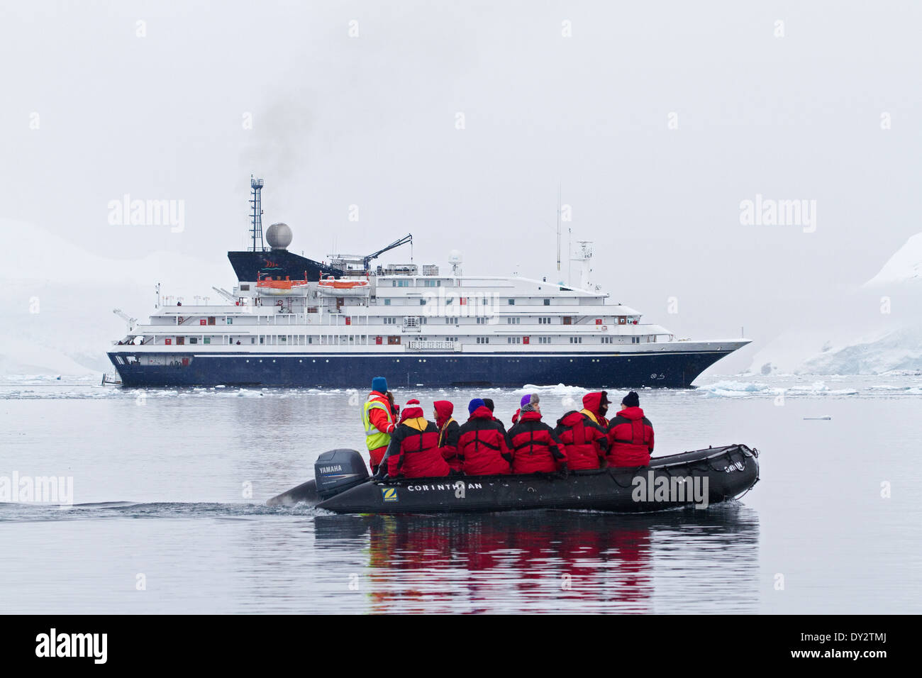 Antarctica cruise ship Antarctica tourism expedition with tourists and Zodiac among glacier and ice on Antarctic Peninsula. Stock Photo