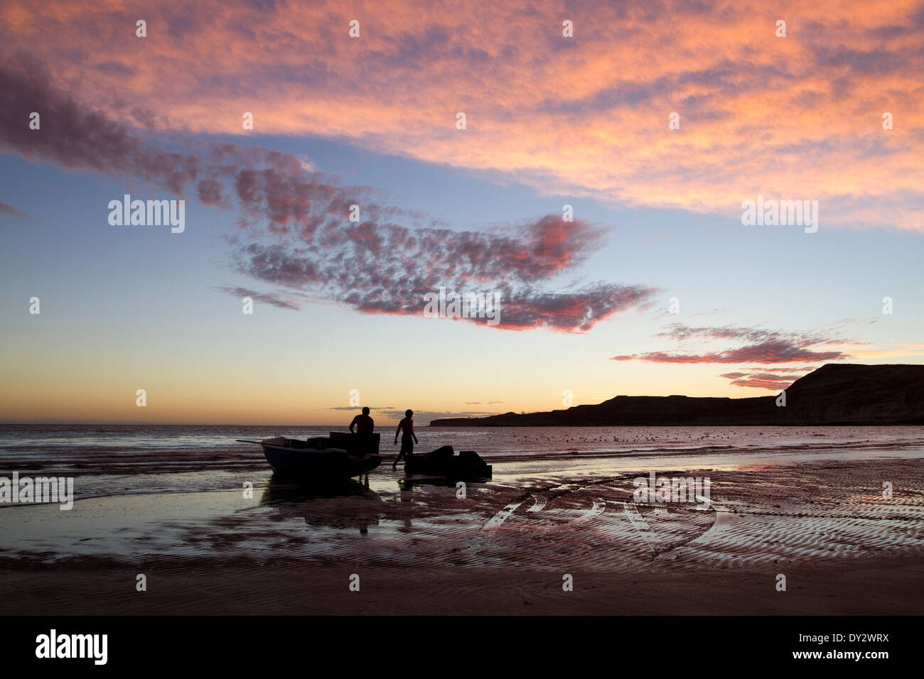 Argentina Sunset sky with fisherman at the beach of Puerto Piramides, Peninsula Valdes, Valdez, Patagonia, Argentina. Stock Photo