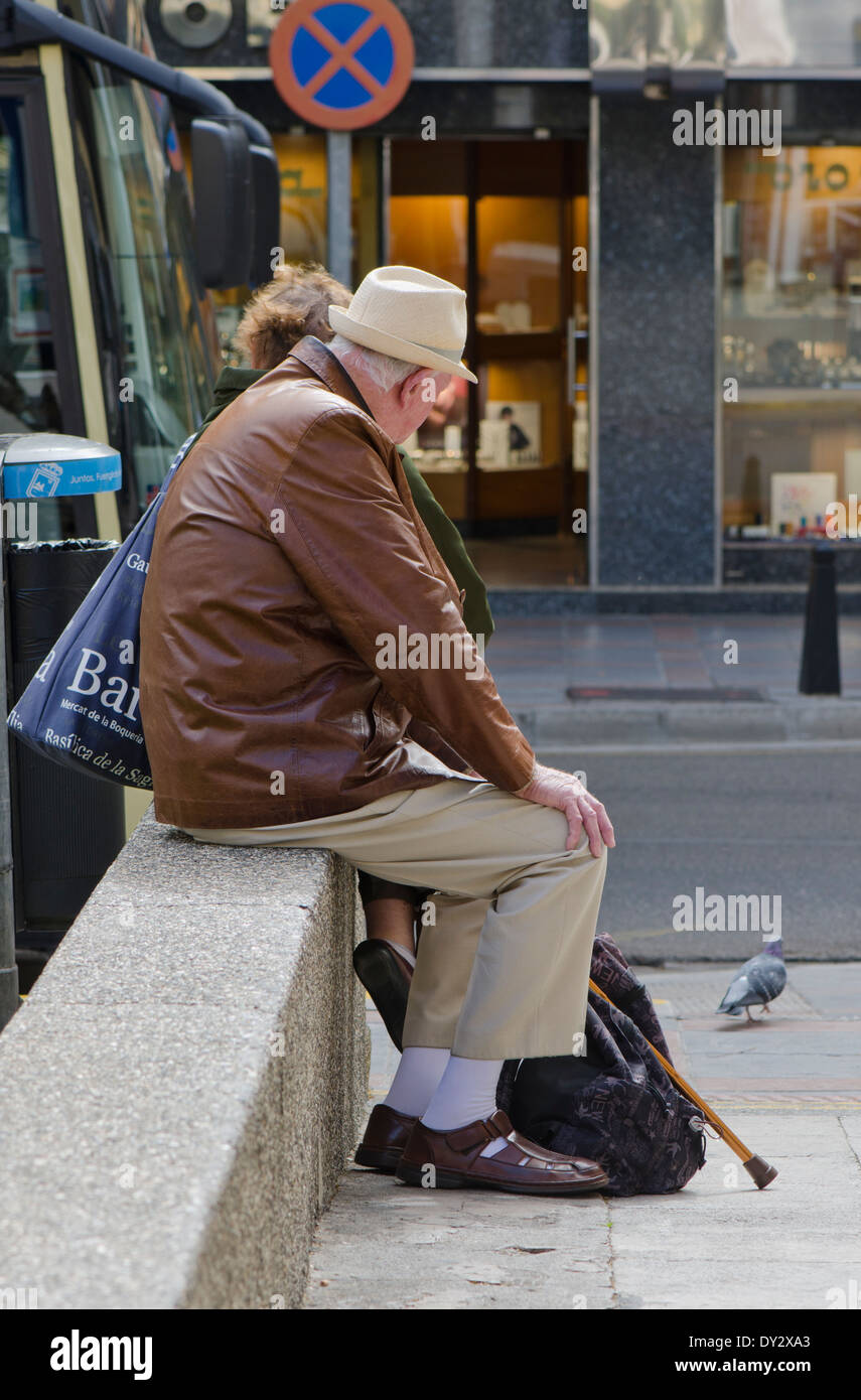 Older man with cane, waiting for the bus. Spain. Stock Photo