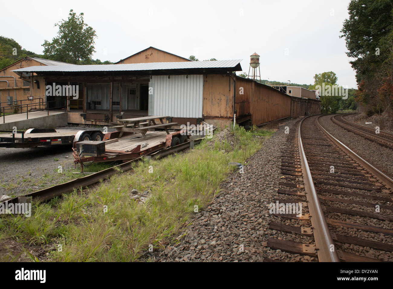 Railroad Tracks Swing Past An Aging Manufacturing Building