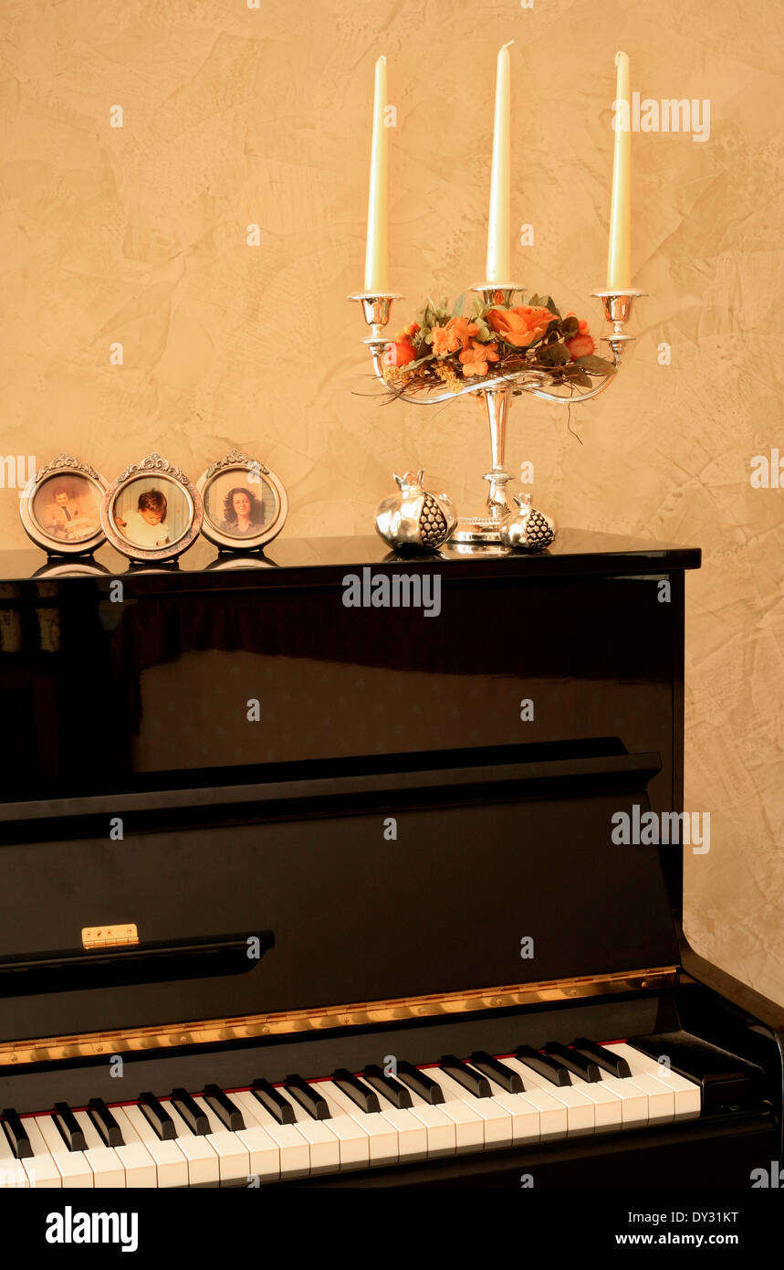 Piano decorated with photos and candelabra Stock Photo Alamy