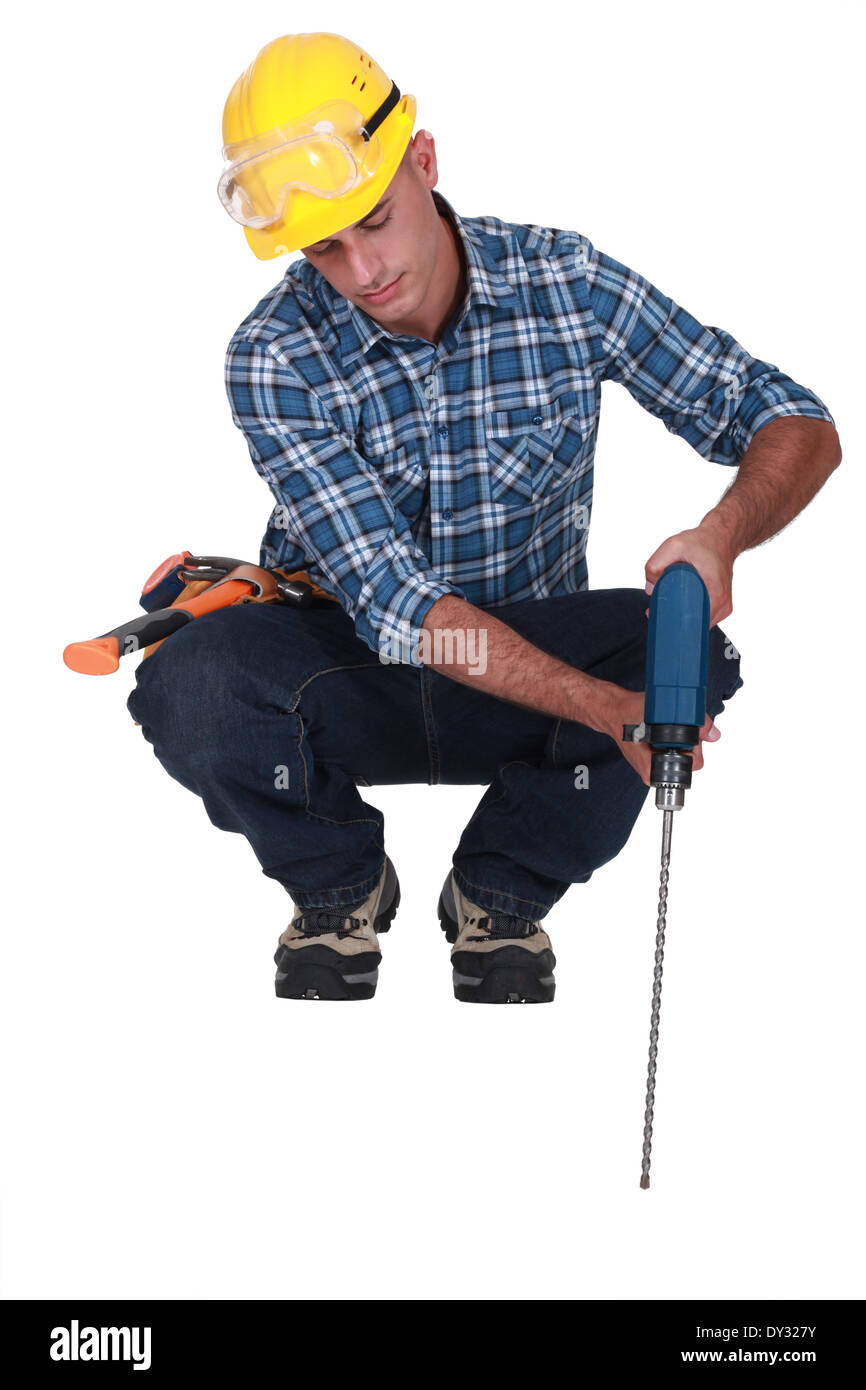 Man drilling into floor Stock Photo Alamy