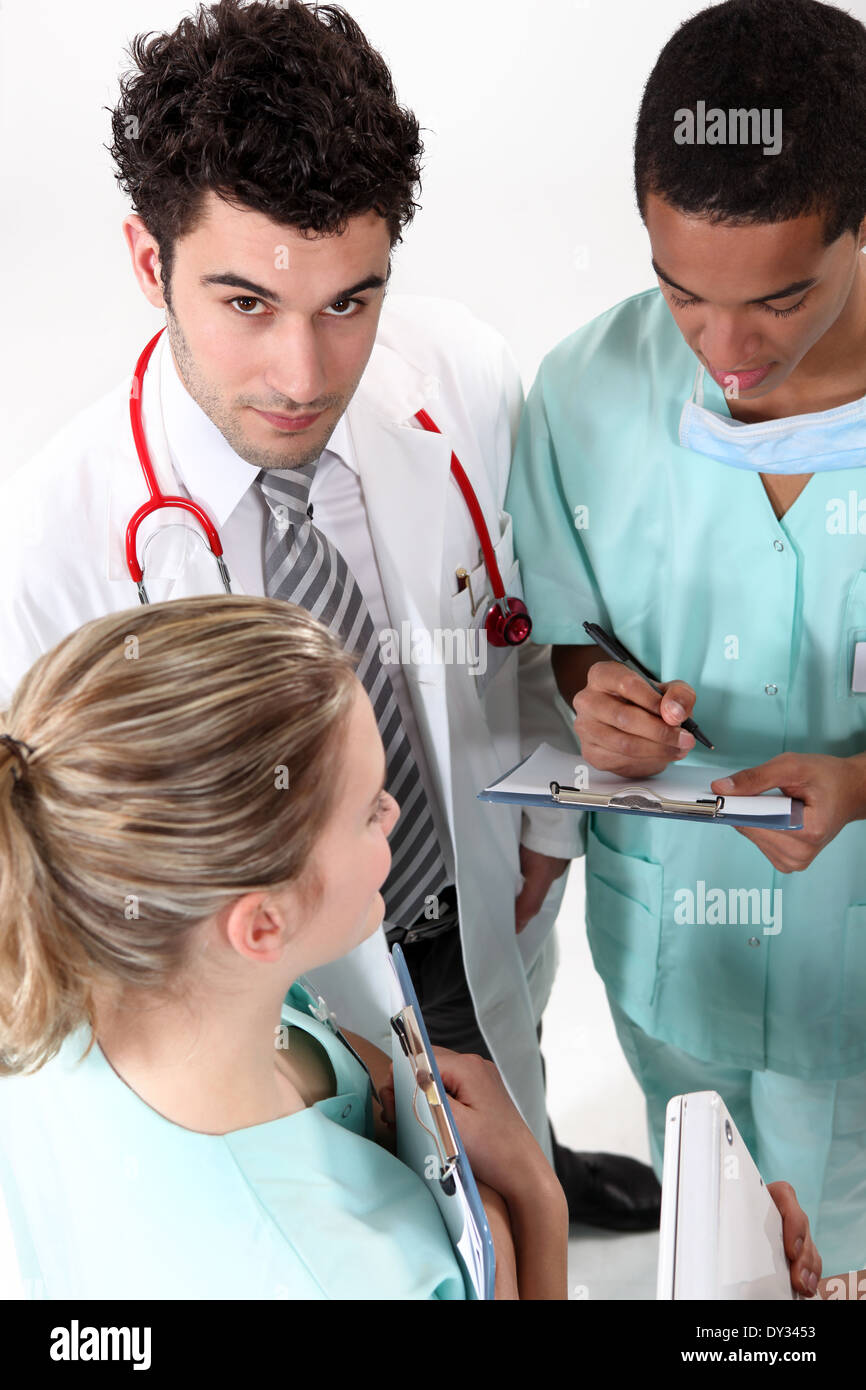 Medical team looking clipboard hi-res stock photography and images - Alamy