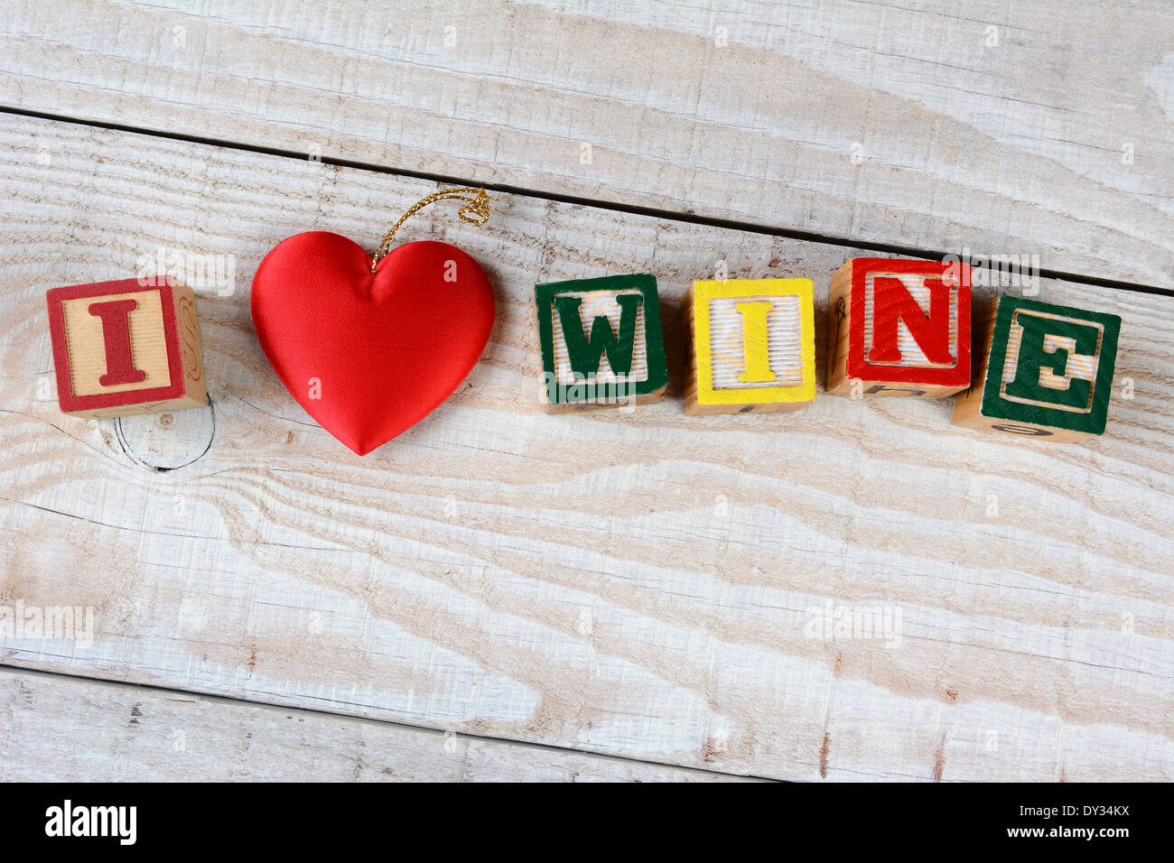 Childrens Blocks Spelling Out I Love Wine. The word Love being represented by a red heart. Stock Photo