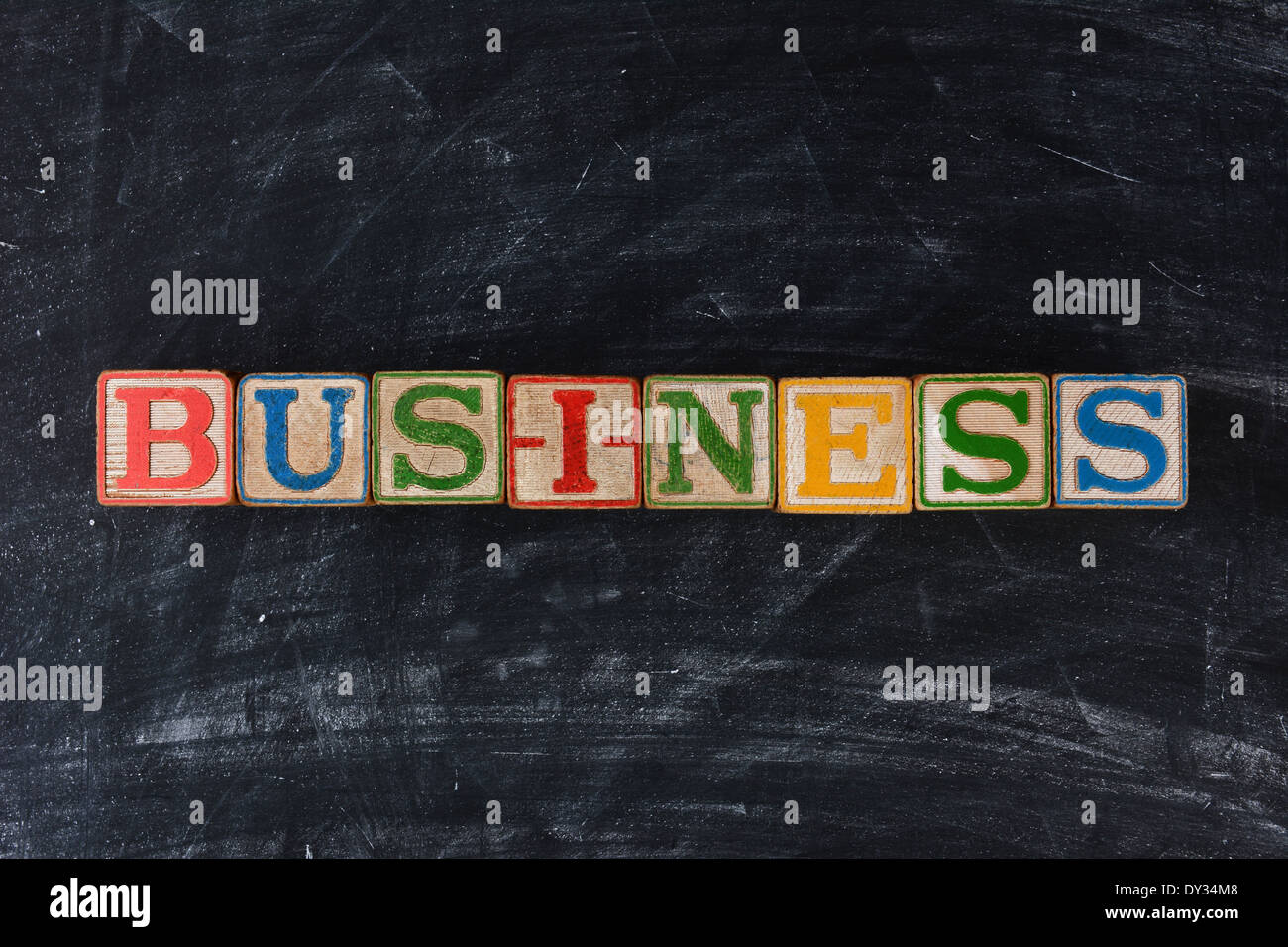 Colorful childrens blocks spelling out Business on a chalk board. Horizontal format. Stock Photo