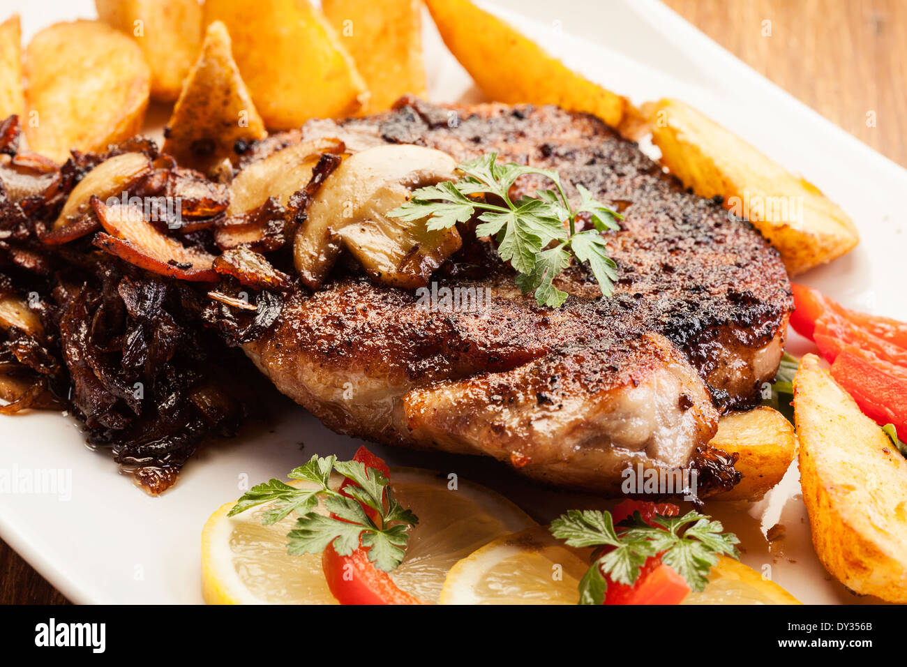 Fried pork chop with mushrooms and chips Stock Photo
