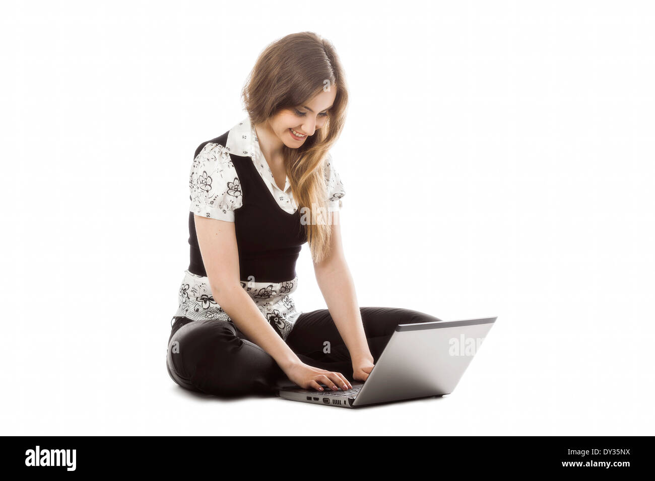 Pretty young woman using a laptop on white background Stock Photo - Alamy