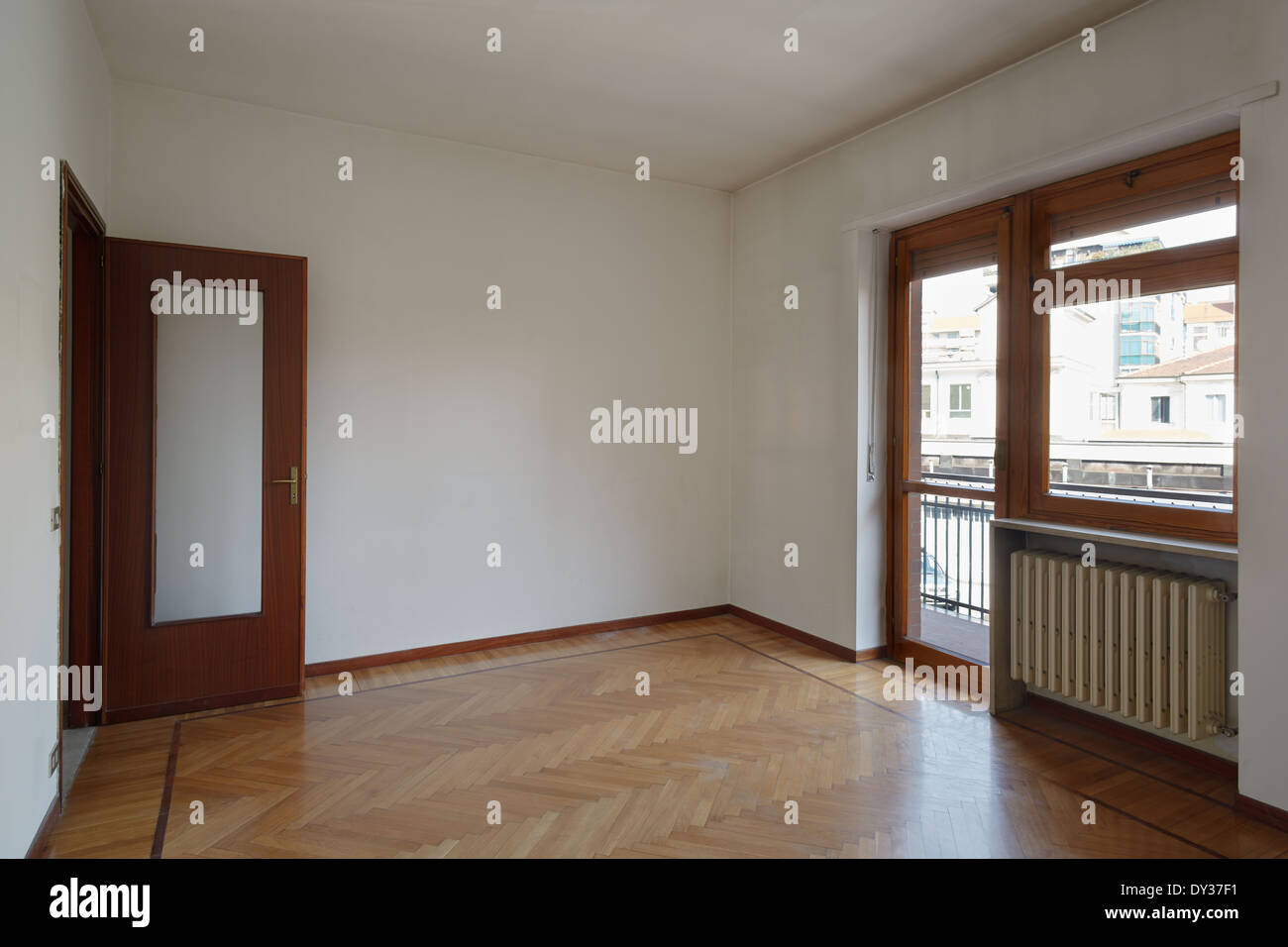 Empty room in normal apartment with wooden floor Stock Photo