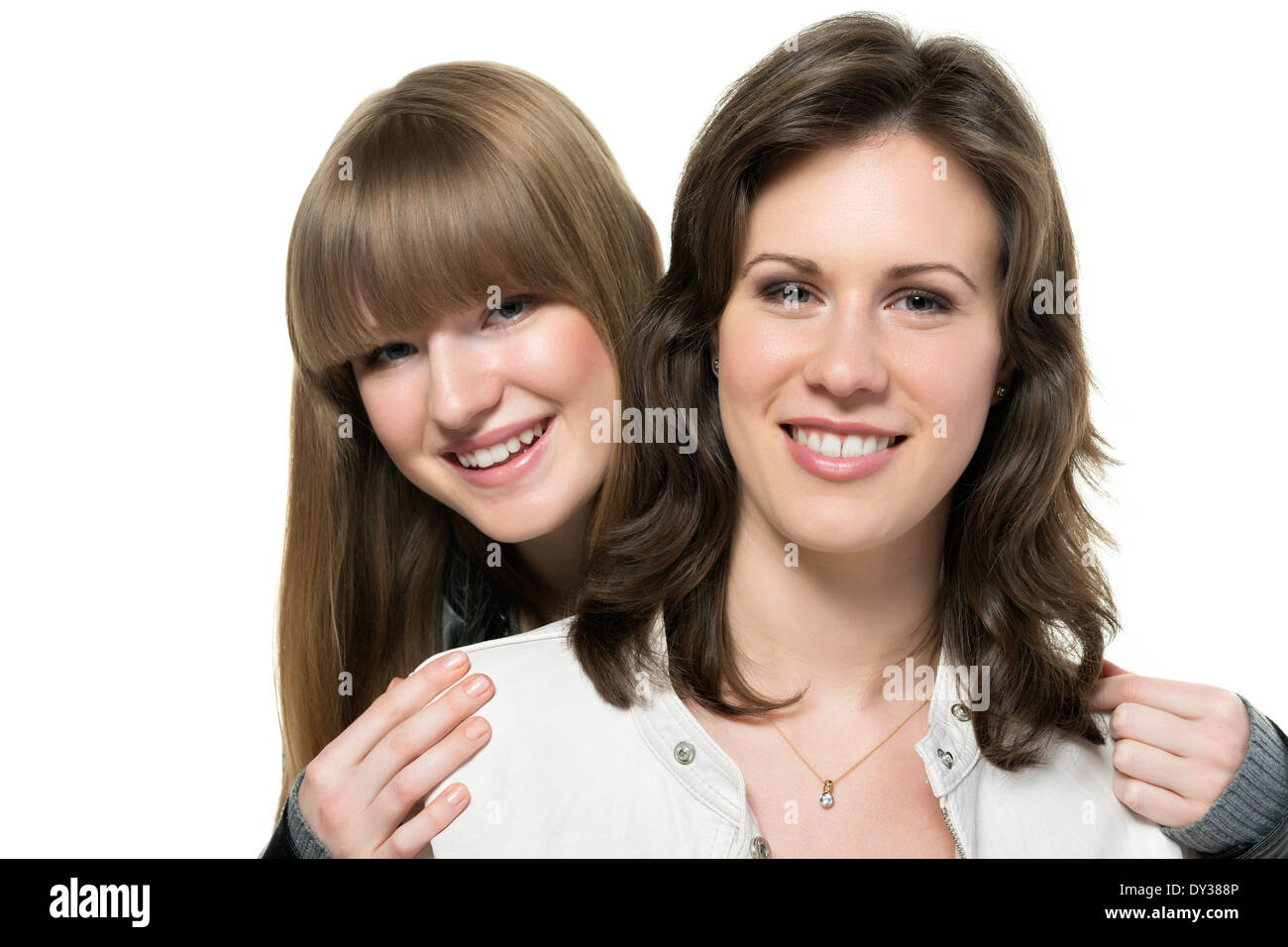 Portrait of two happy woman, blond and brunette, with black and white leather jacket, isolated on white background Stock Photo