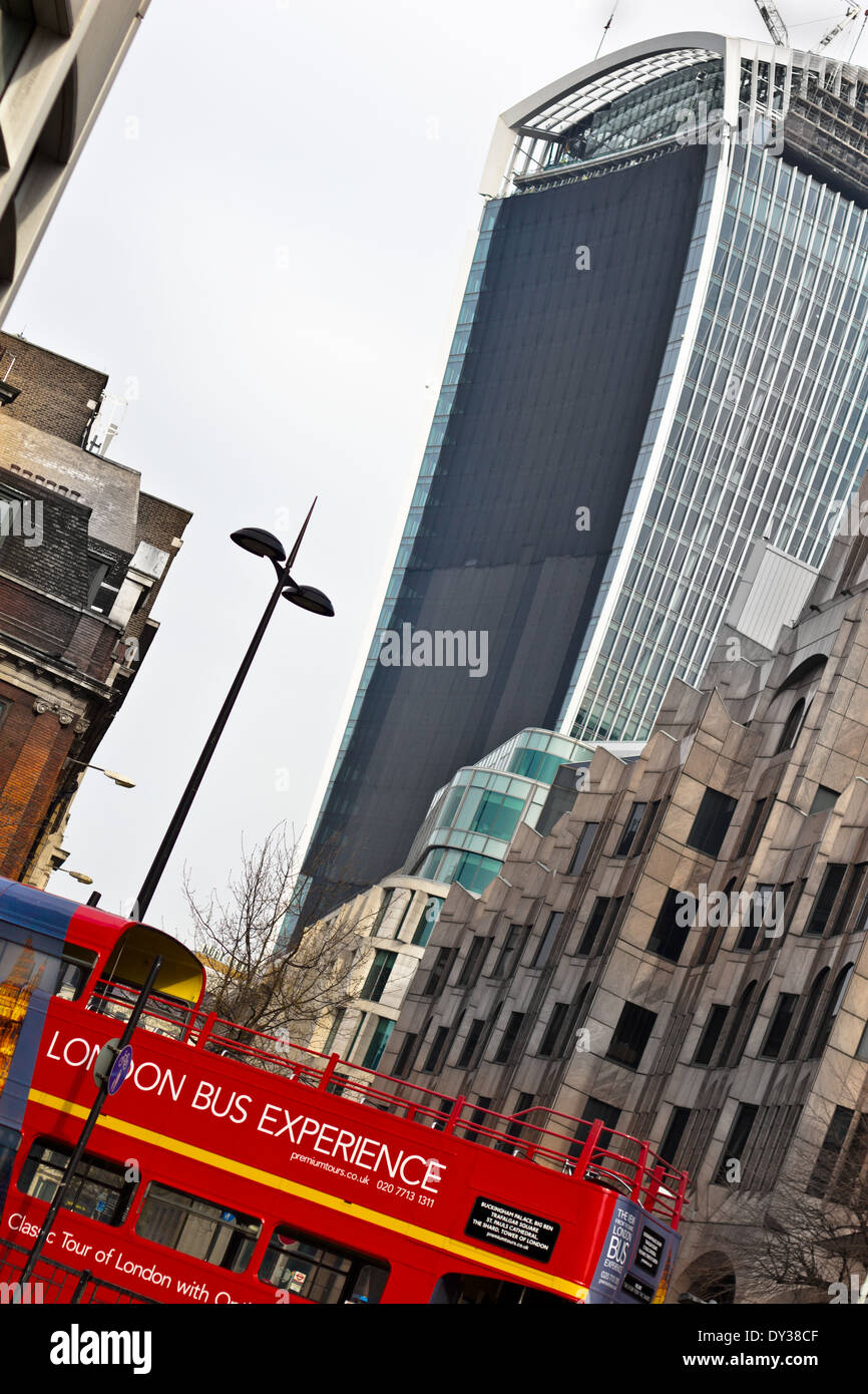 walkie talkie building 20 Fernchurch Street London. View on grey day with red tour bus on the foreground near Tower of London Stock Photo