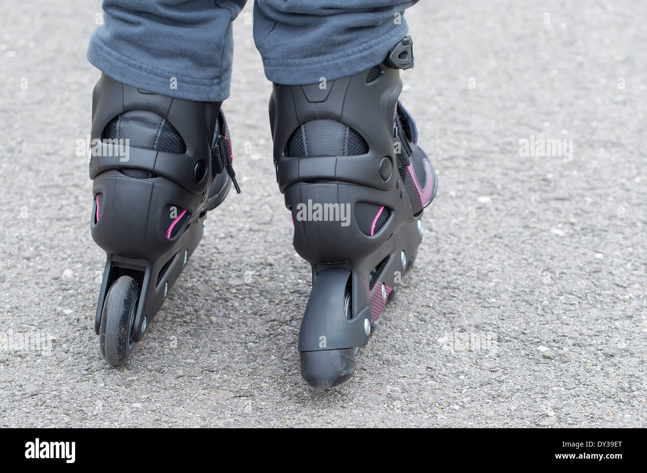 Foreground of inline skates, girl skating on the street Stock Photo Alamy