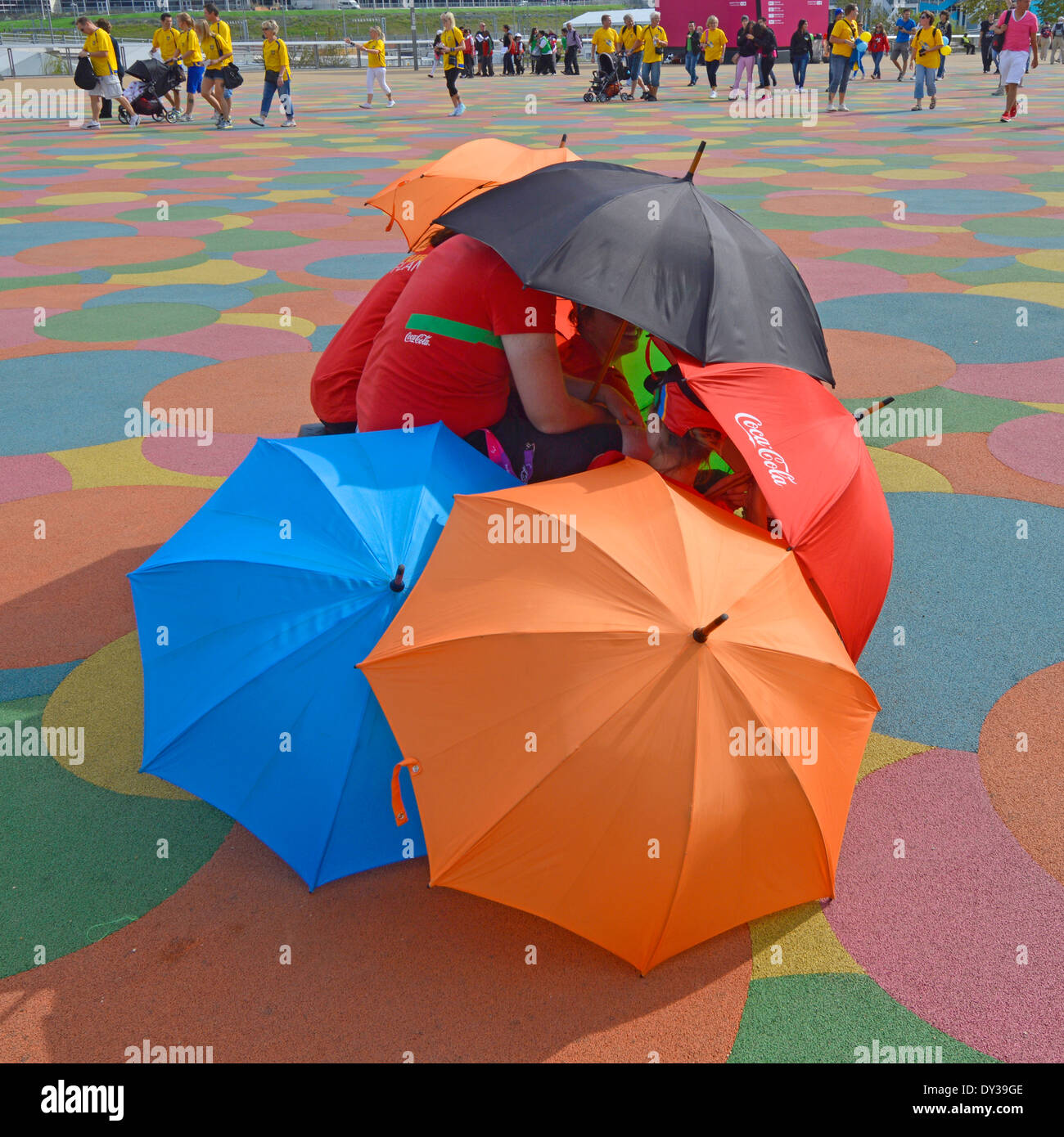 Providing entertainment during the London 2012 games in the Olympic Park popping out from under umbrellas (also Alamy DYJGFC) Stock Photo