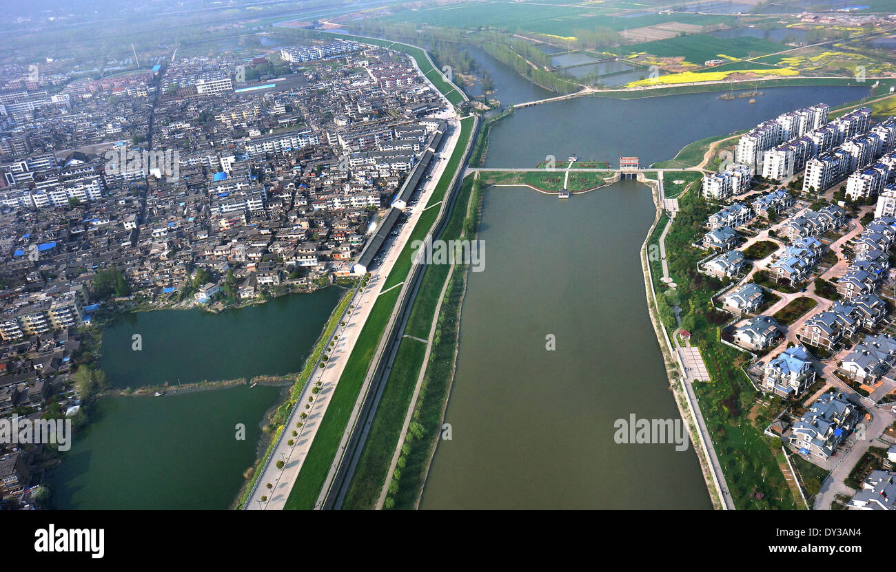 (140405) -- SHOUXIAN COUNTY, April 5, 2014 (Xinhua) -- Photo taken on April 4, 2014 shows the old town area within the ancient city wall (L), and the new town area on the other side of the river in Shouxian County, east China's Anhui Province. The city wall of Shouxian County, along with its four barbicanned gates, was first built up during the Southern Song Dynasty (1127-1279 AD). The 7,147-meter stone brick structure is the only ancient Chinese civic fortification that has remained intact. (Xinhua/Tao Ming) (lmm) Stock Photo