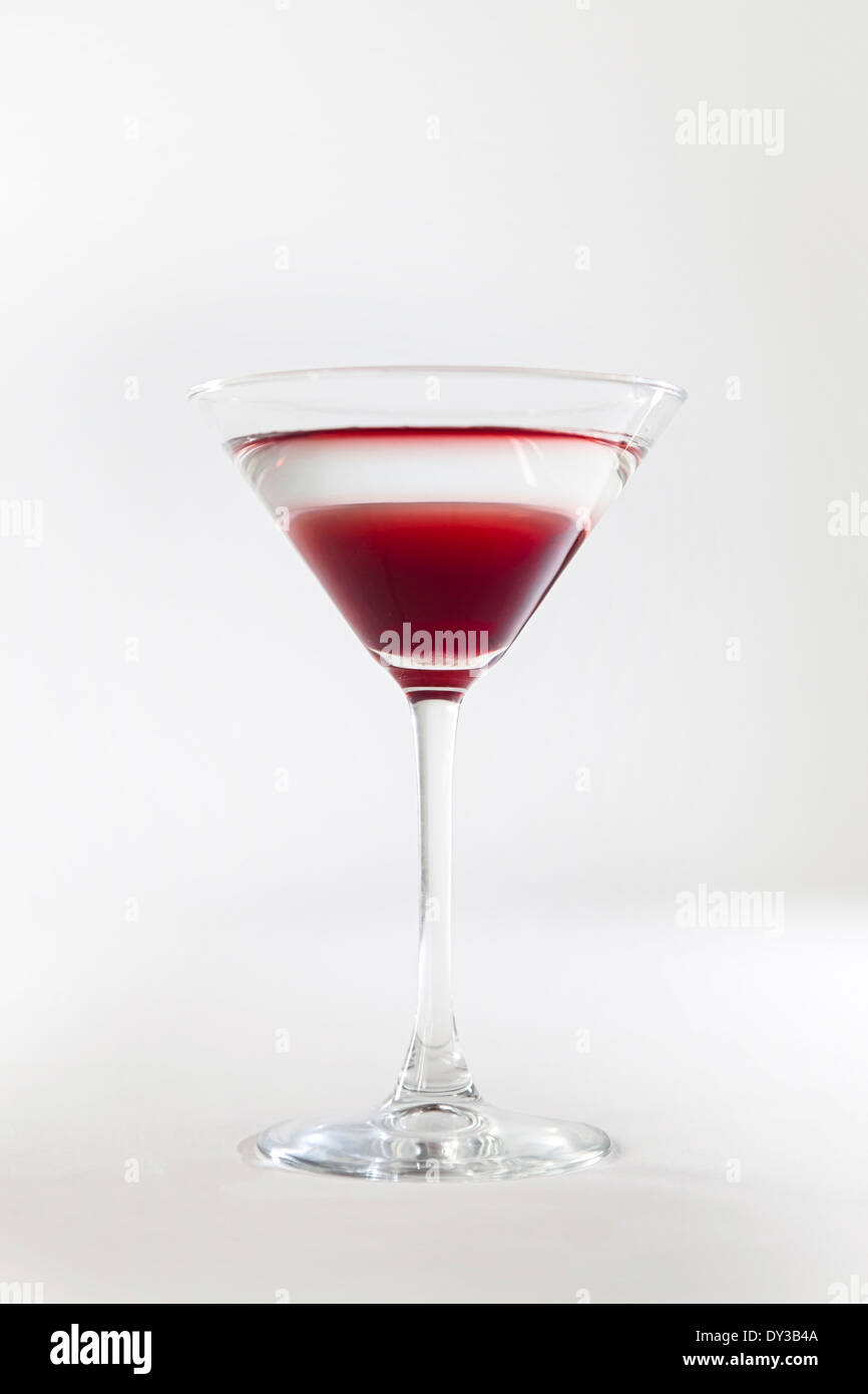 Layered red and transparent cocktail in a martini glass Stock Photo