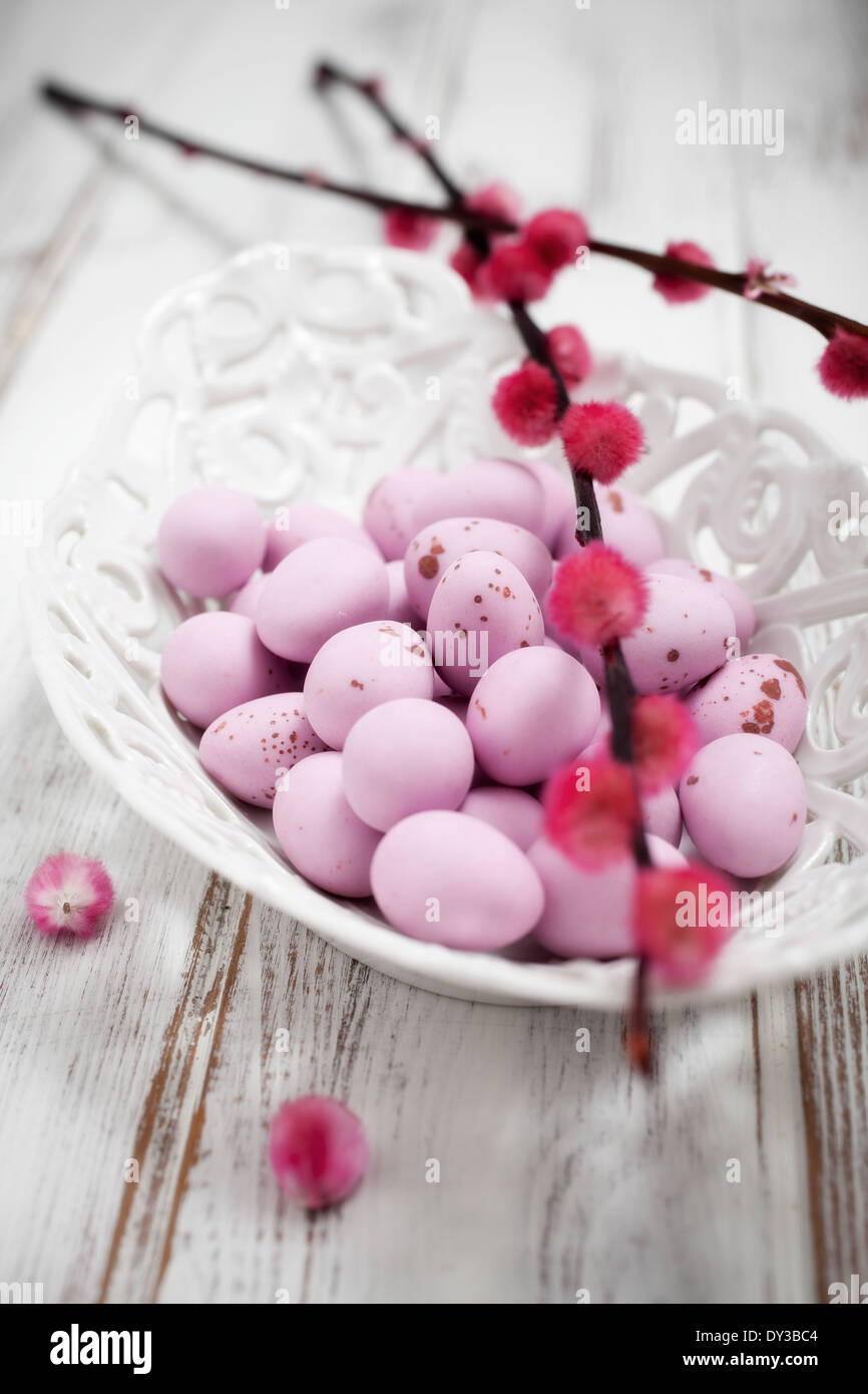 Pink Easter chocolate eggs in white bowl Stock Photo