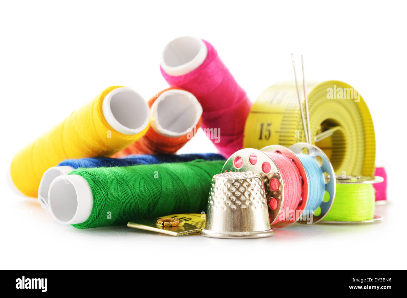 Composition with tailor needles and threads over white background Stock Photo