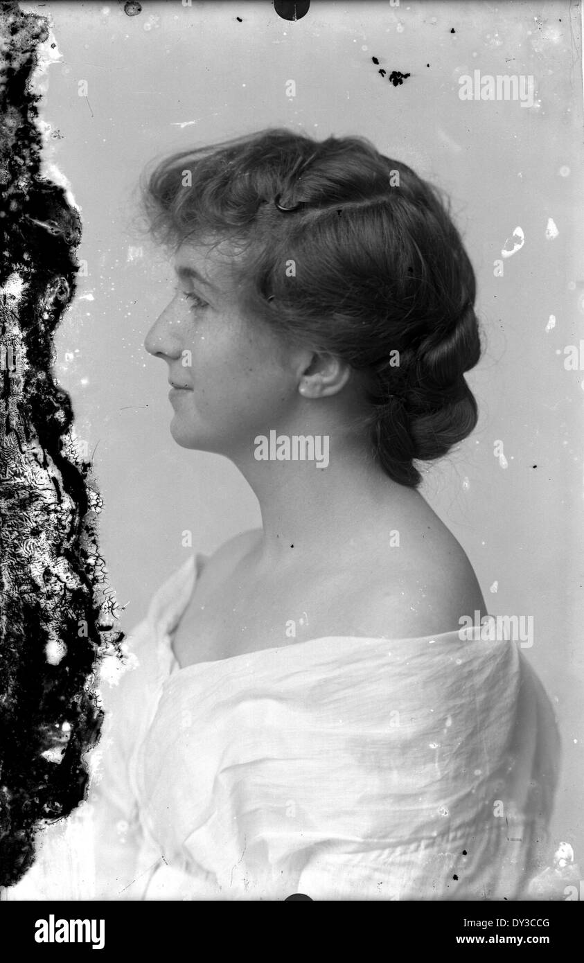 A portrait of a woman, captured in a black and white photograph. The ...