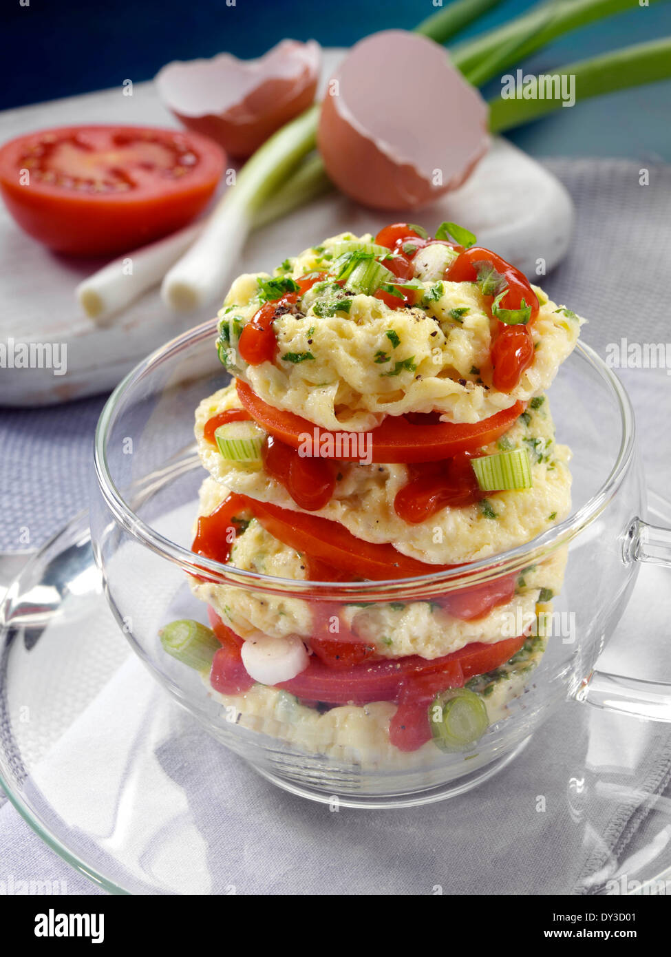 Herb omelette stack cooked in a glass cup individual portion Stock Photo