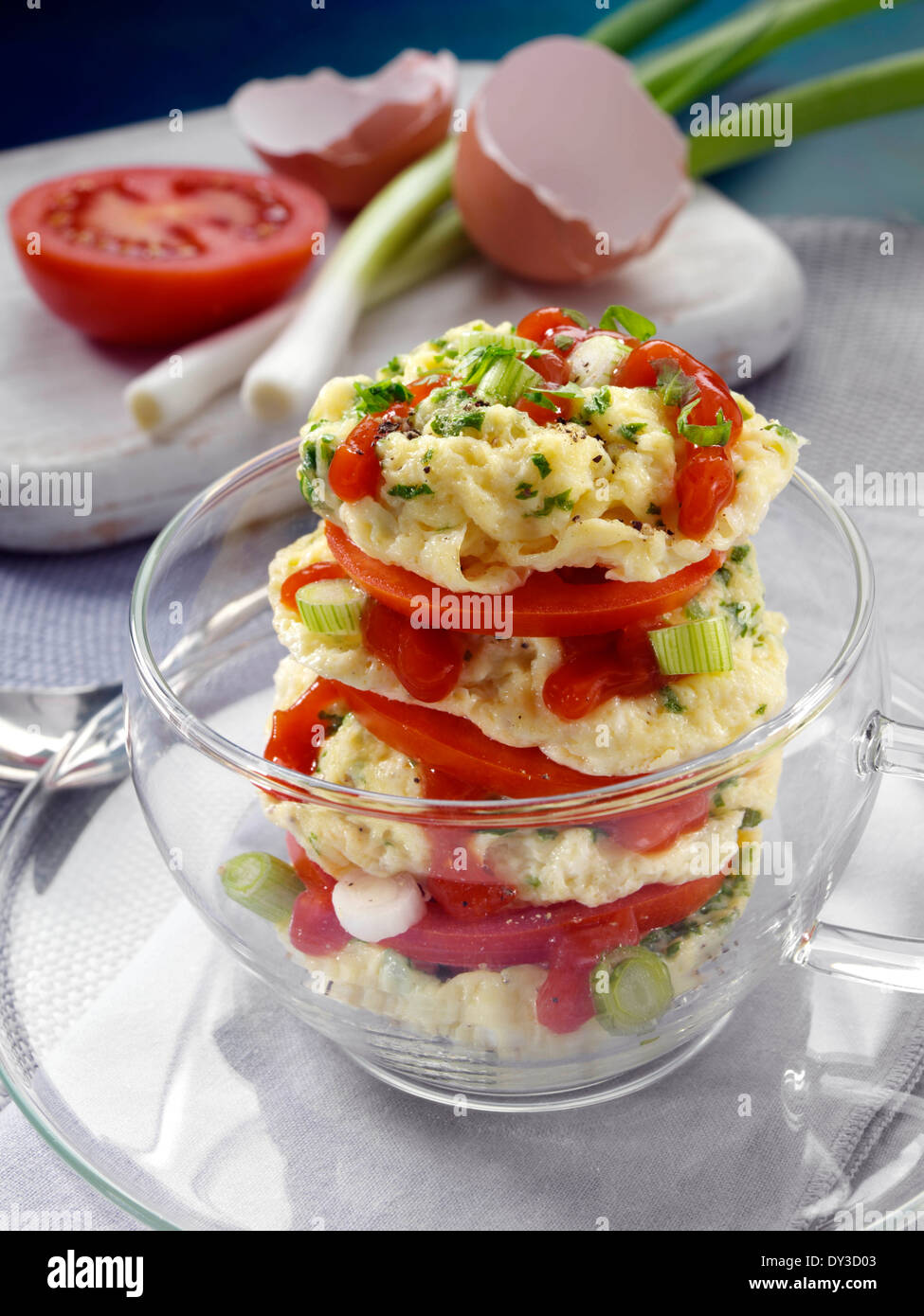 Herb omelette stack cooked in a glass cup individual portion Stock Photo