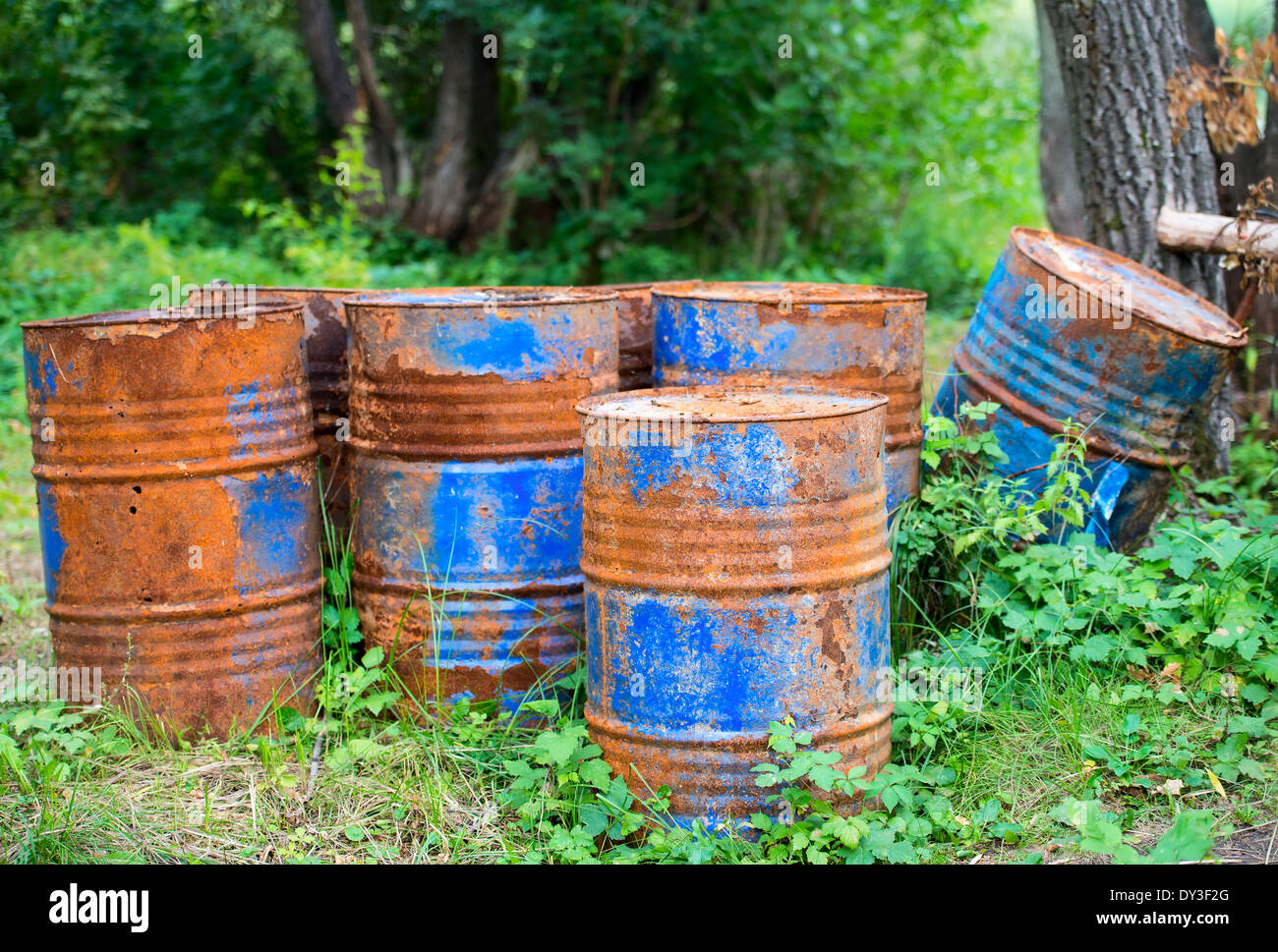 old rusty metal painted barrels outdoors Stock Photo