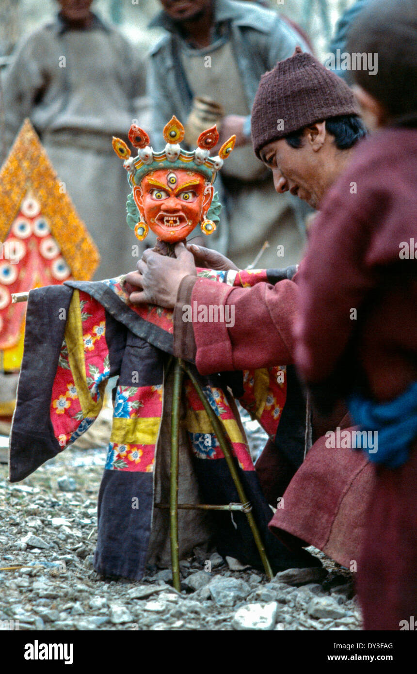 Ladakh man puppet master kneeling Cham dance puppet goncha wool hat