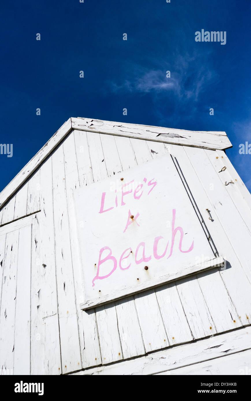 'LiFe's A Beach' painted sign on a white beach hut. Stock Photo