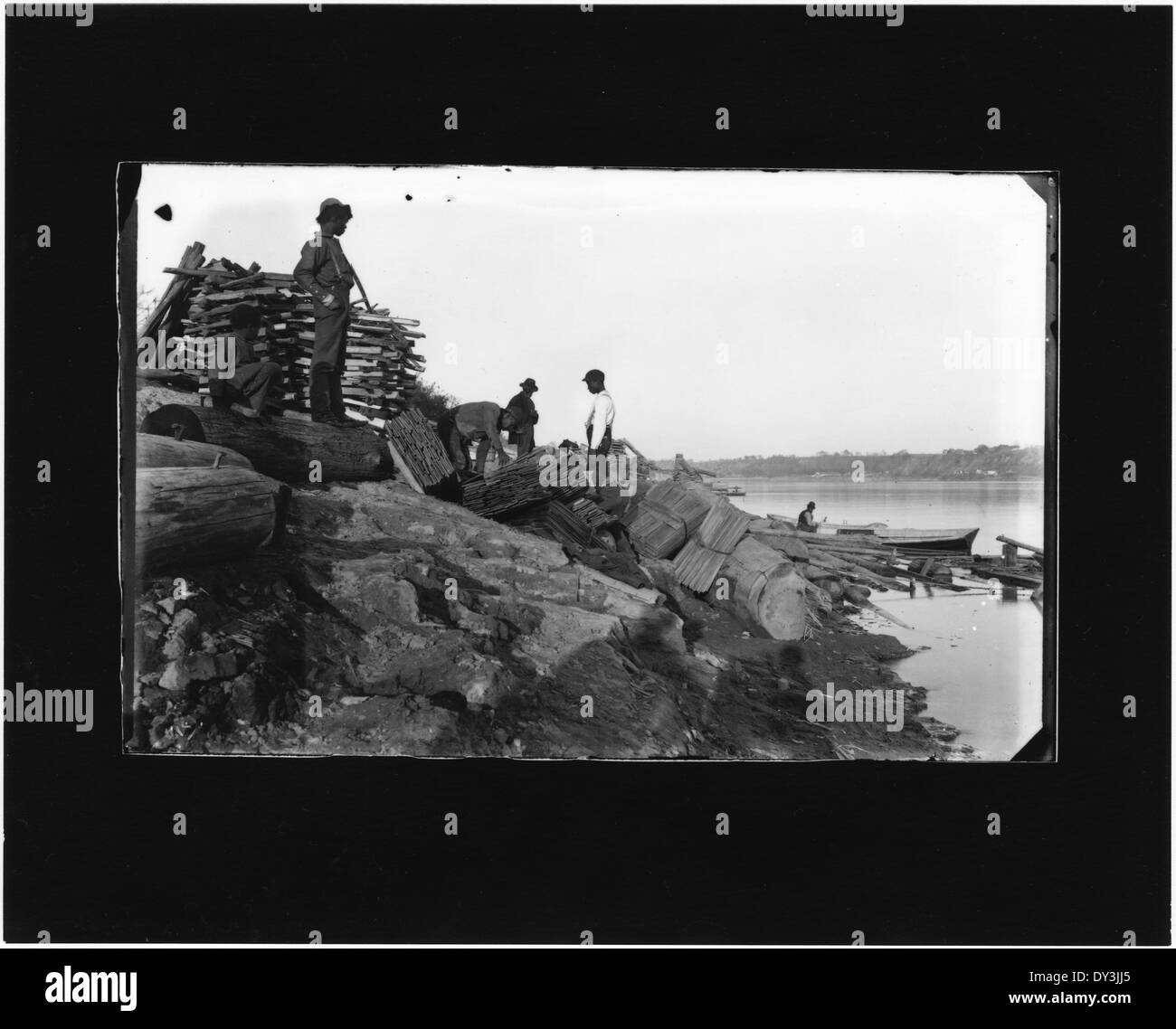 Men on riverbank Stock Photo