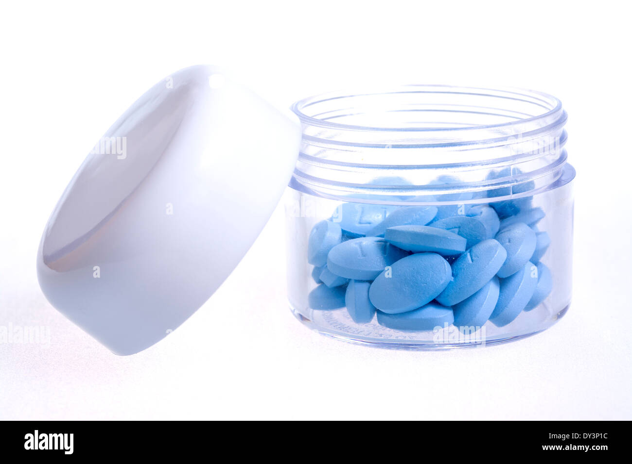 Little blue pills in a small bottle Stock Photo
