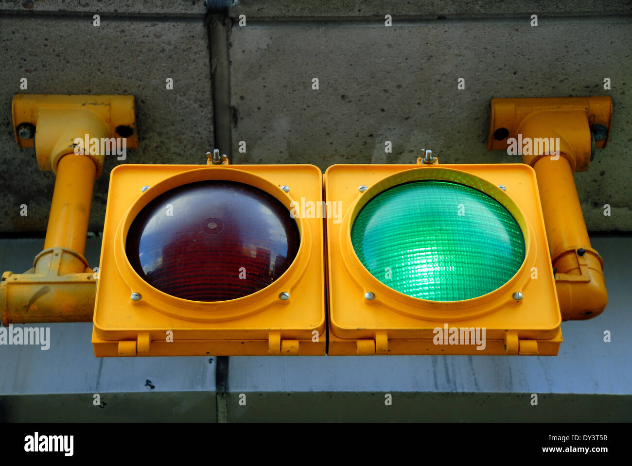 A traffic light at a parking garage is illuminated green, for go. Stock Photo