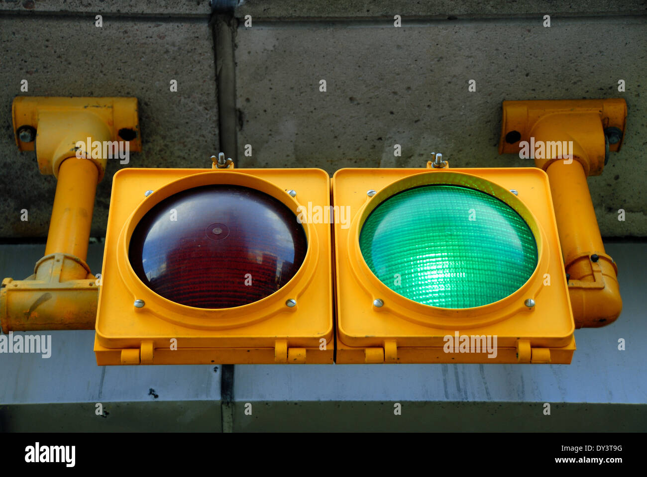 A traffic light at a parking garage is illuminated green, for go Stock