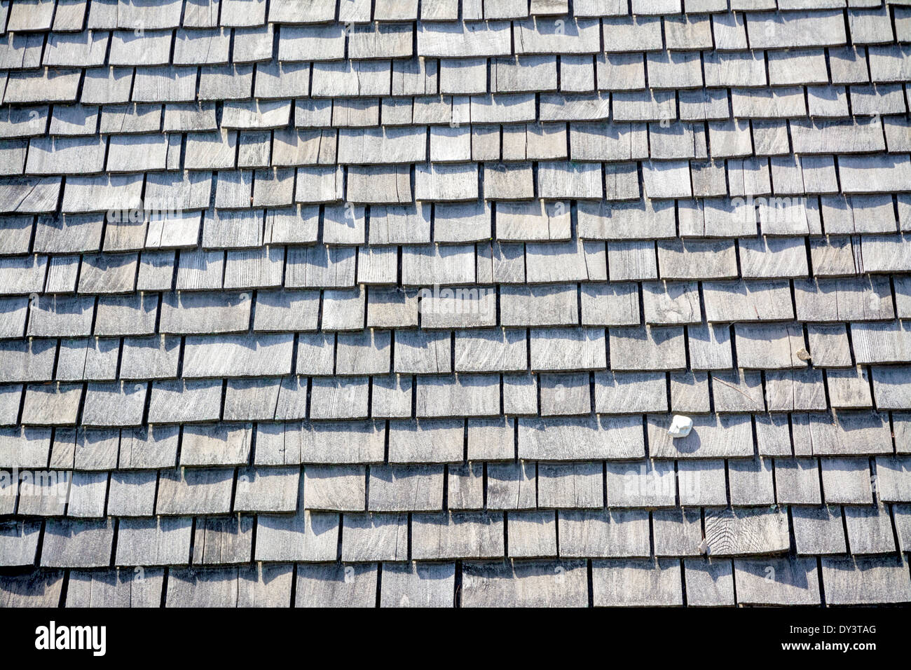 Wooden roof shingles and a single rock Stock Photo