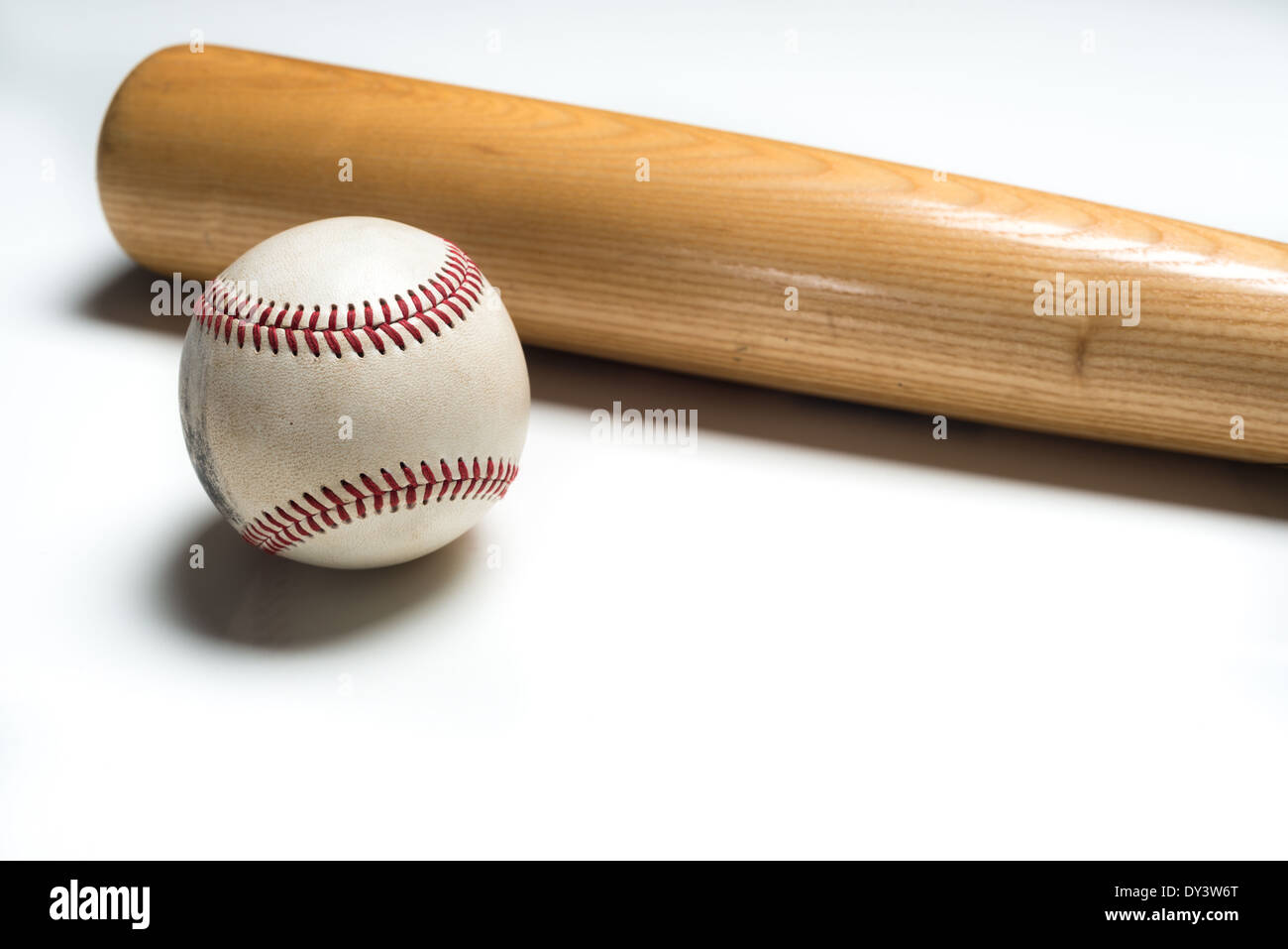 A wooden baseball bat and ball on a white background Stock Photo