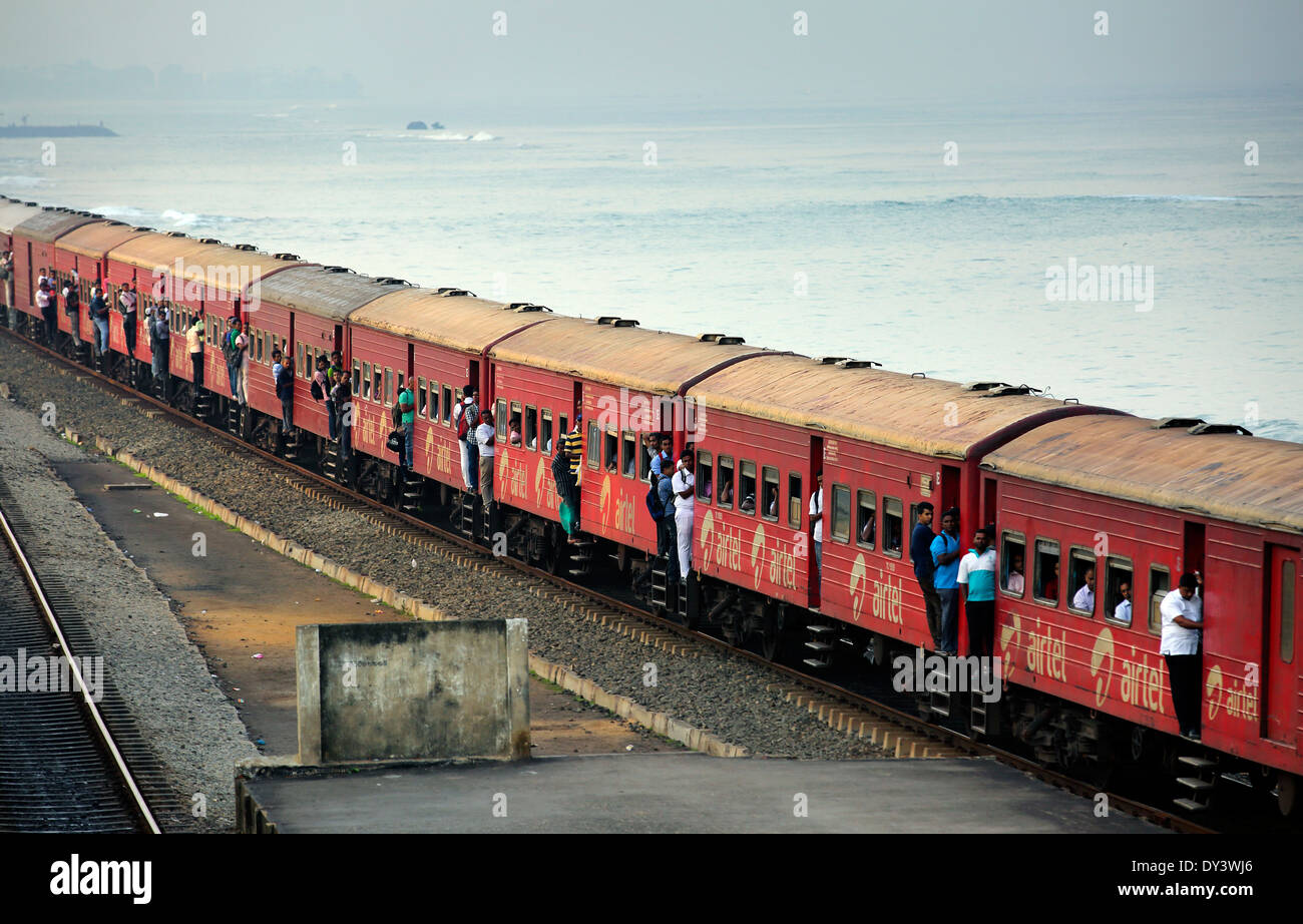 Train passing through Bambalapitiya Railway station with male commuters ...
