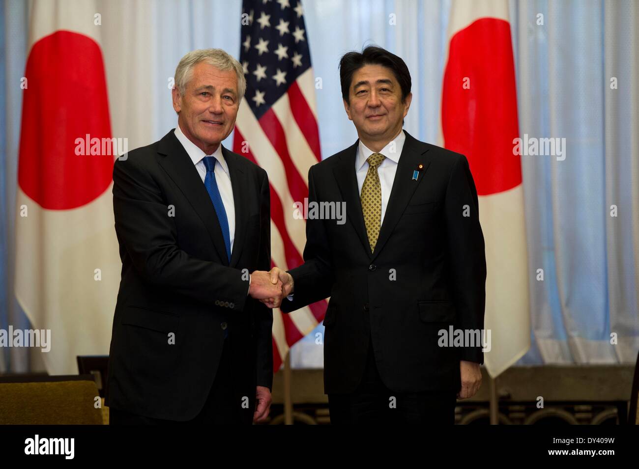 US Secretary of Defense Chuck Hagel greets Japanese Prime Minister Shinzo Abe at the Prime Ministers official residence Sori Daijin Kantei April 5, 2014 in Tokyo, Japan. Hagel announced the deployment of drones and missile destroyers to bolster US-Japan defense alliance. Stock Photo