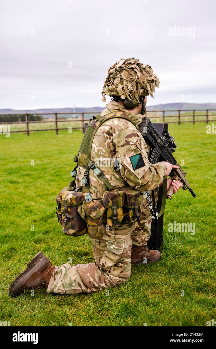 A soldier from the Royal Irish Regiment trains on a military firing range with an SA80 L85A2 Stock Photo