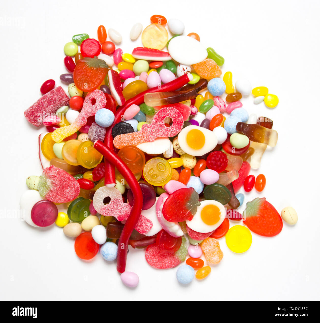 A pile of colourful sweets on a white surface Stock Photo