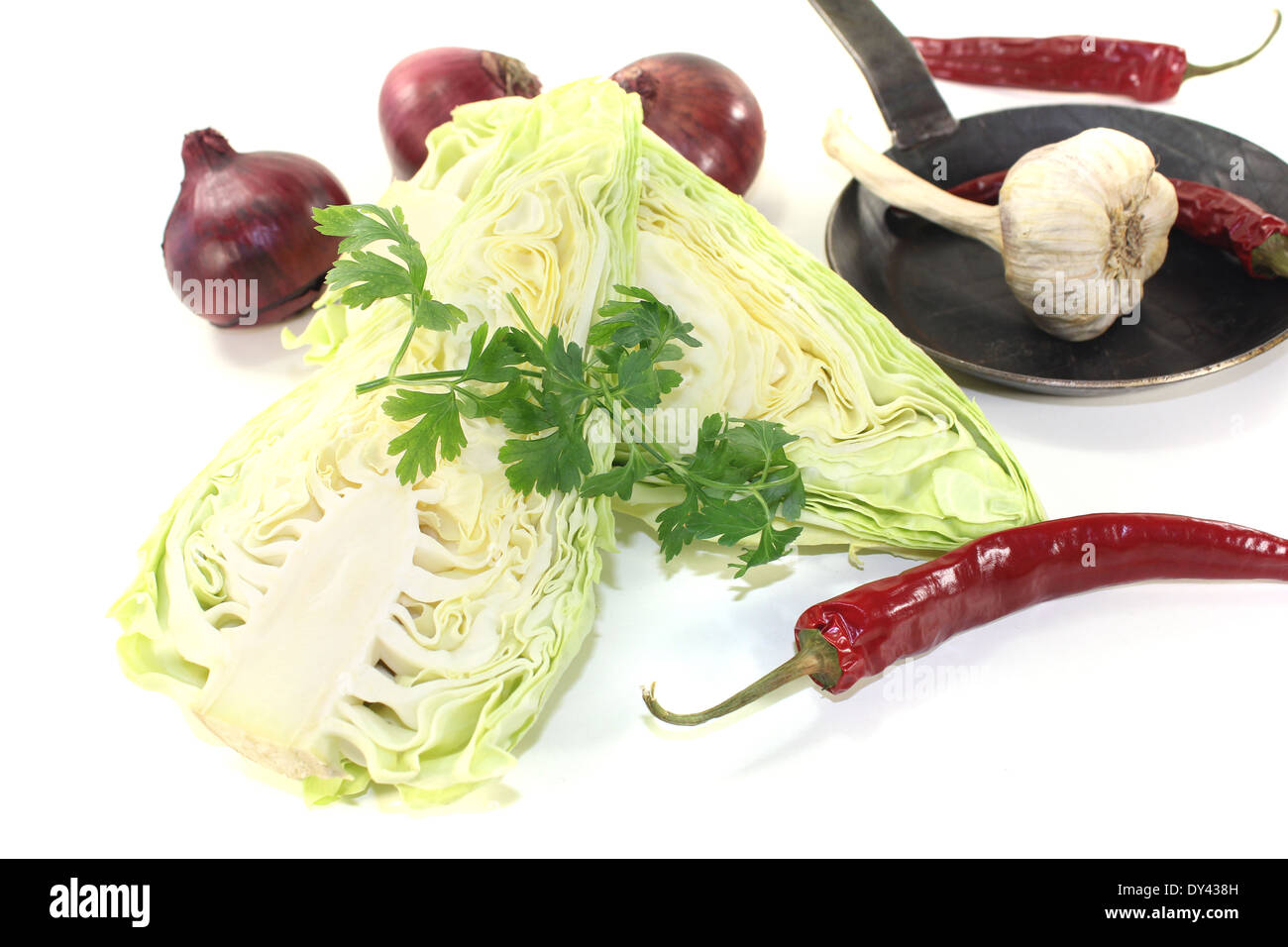 pointed cabbage with onions in a pan on a light background Stock Photo