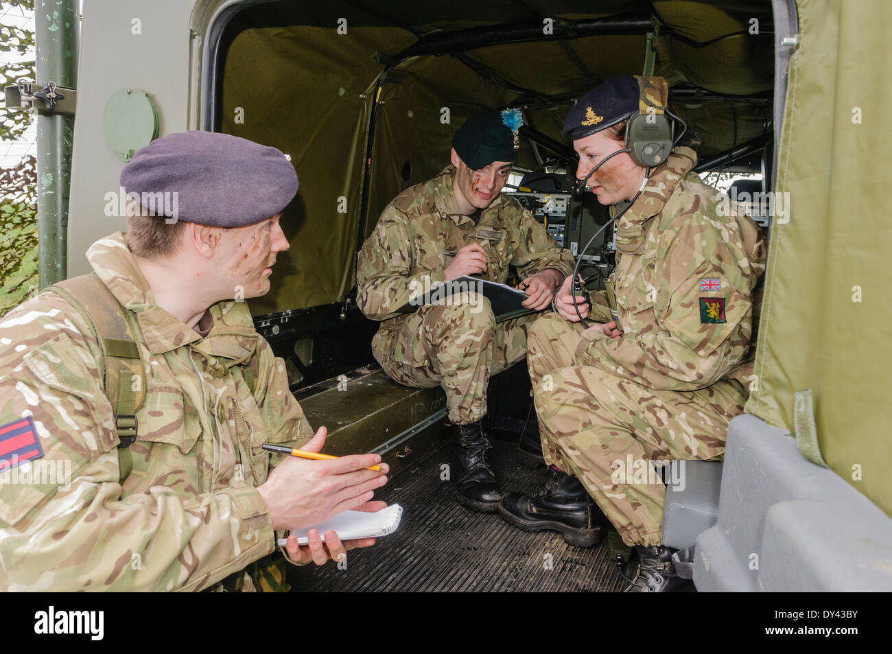 A Royal Artillery radio operator relays instructions to a senior officer Stock Photo
