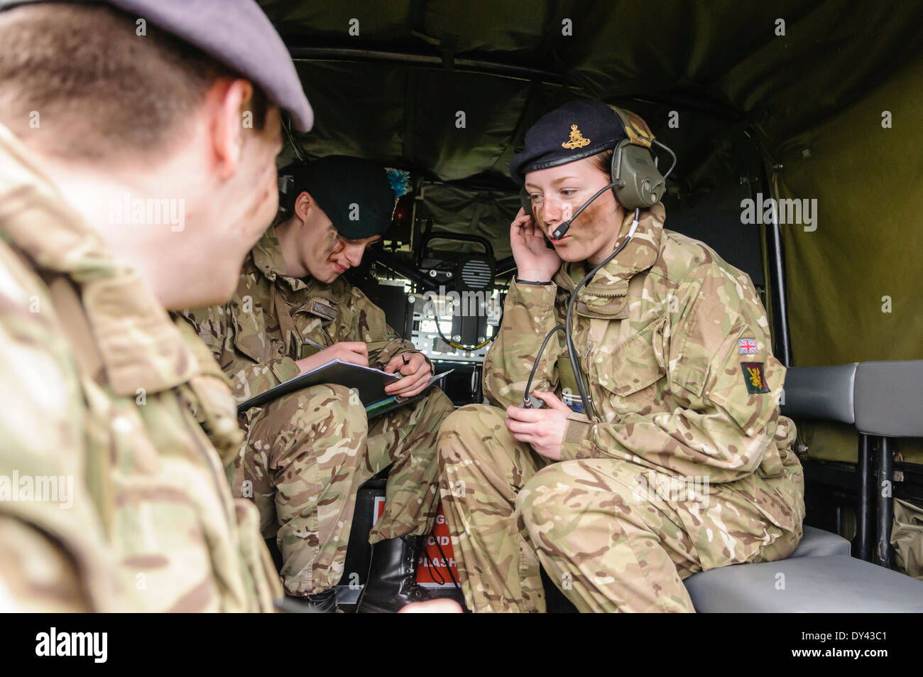 A Royal Artillery radio operator relays instructions to a senior officer Stock Photo