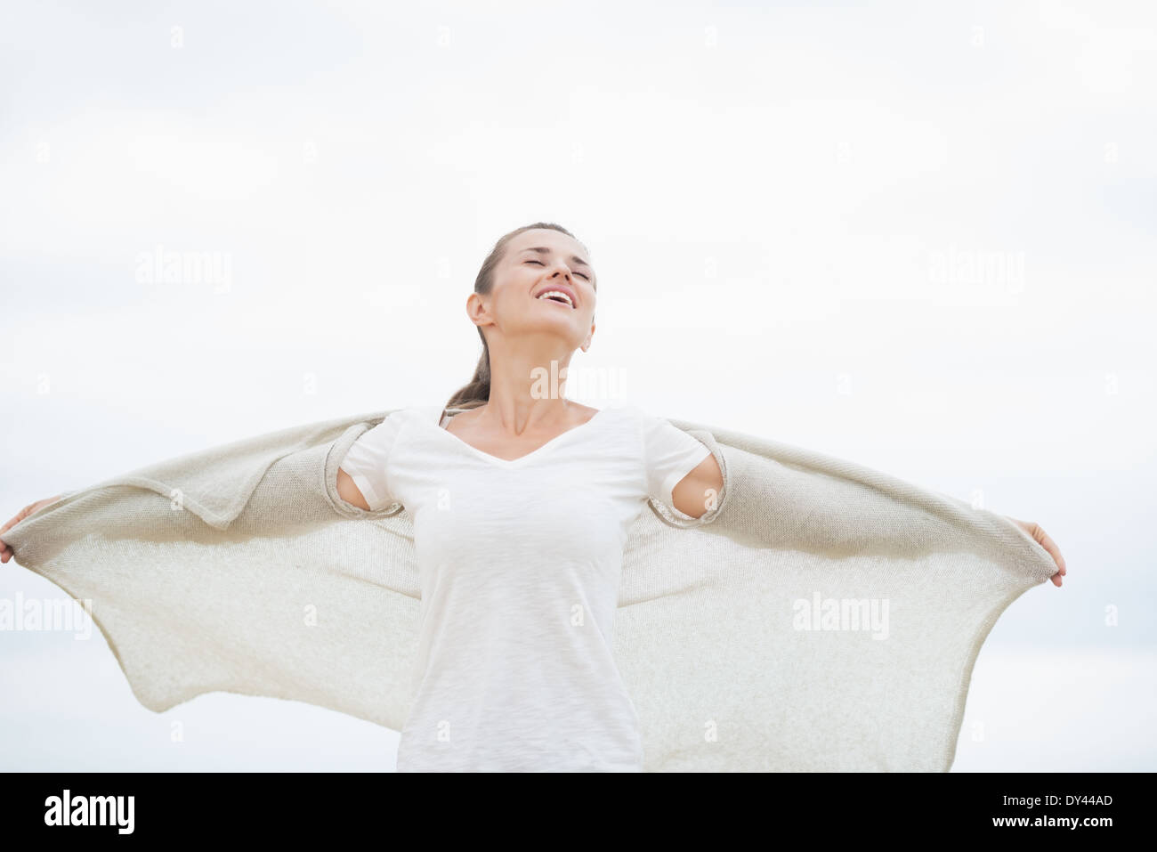 Young woman on cold beach rejoicing Stock Photo